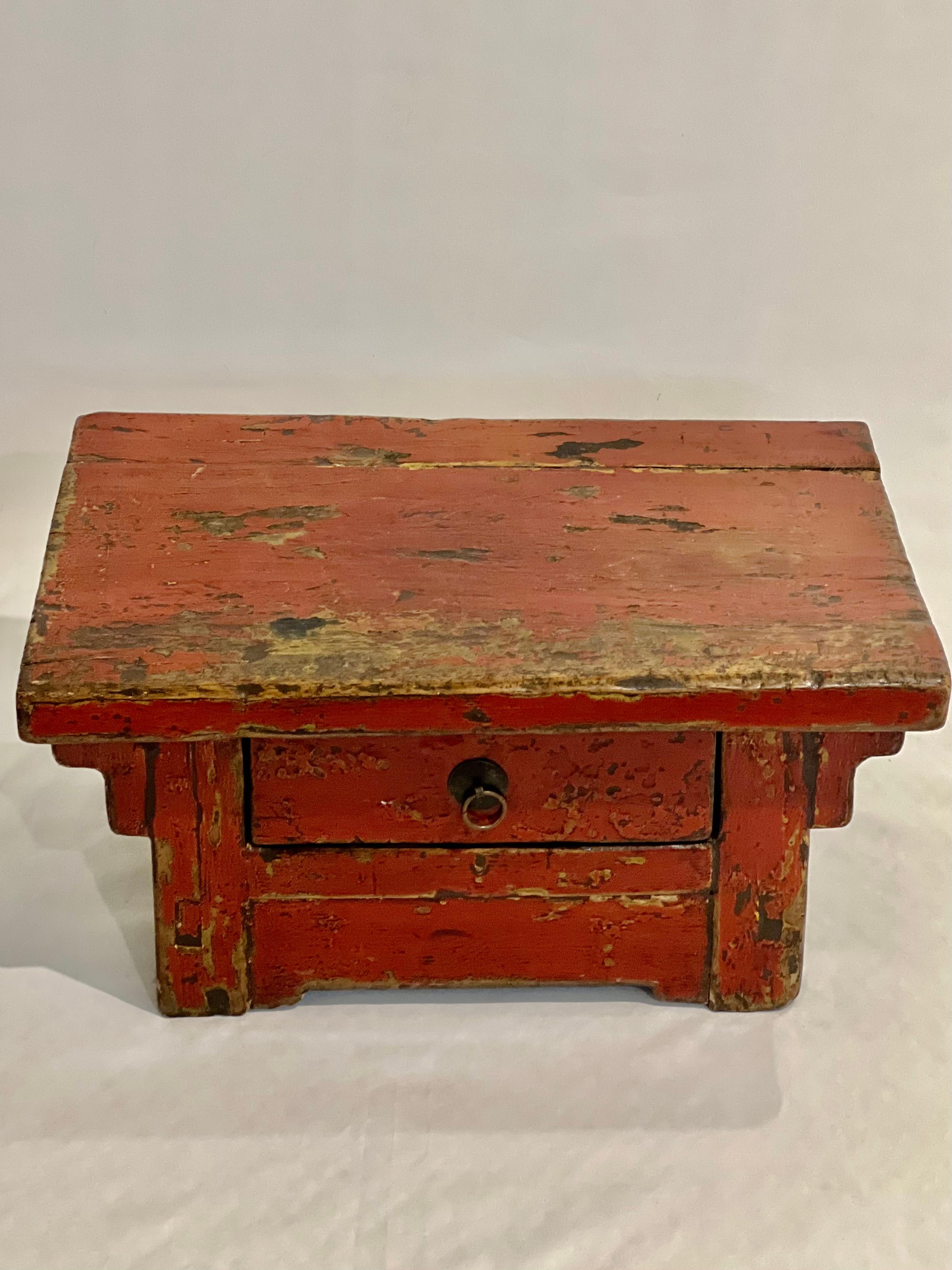 19th century Chinese Ming style red lacquered low tea table.

A finely crafted, petite elm table featuring a single drawer with a brass ring pull. In great vintage condition with fantastic aged patina in a richly hued red lacquer. Originally an