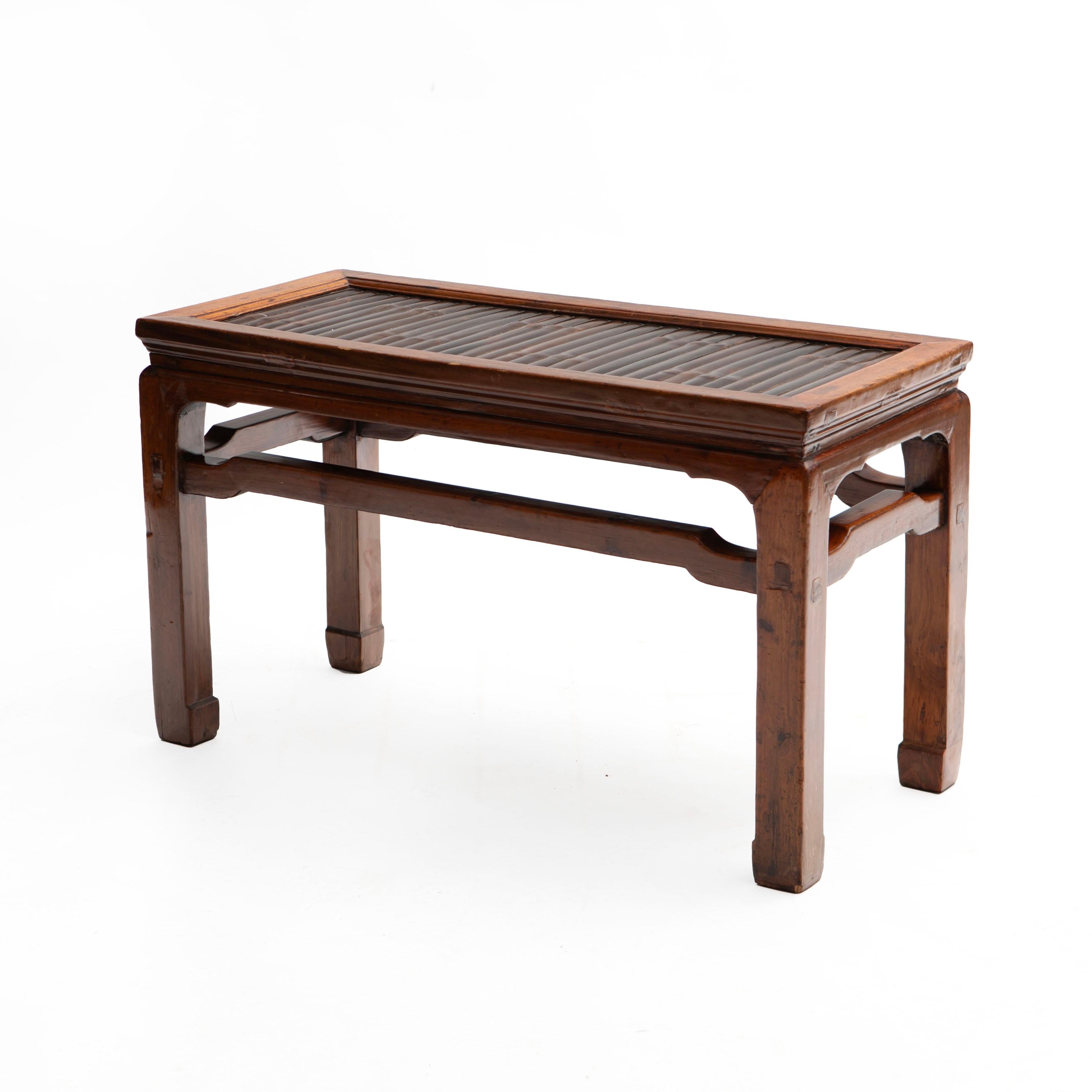 A 19th century Chinese Ming style bench with a walnut frame and a top composed of bamboo slats. Square legs joined with stretchers.

In original good antique condition with beautiful natural patina.
From Suzhou, Jiangsu Province, China, 1840-1860
