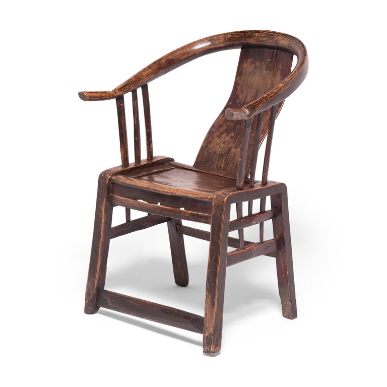 This 19th century moongazing chair from northern China was constructed by a Provincial carpenter who heated and bent willow wood into the rounded and upturned shape of the chair's arms. This simple, sculptural form hearkens back to Classic Chinese