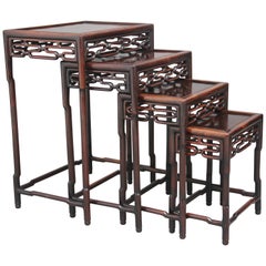 19th Century Chinese nest of four tables with carved frieze decoration