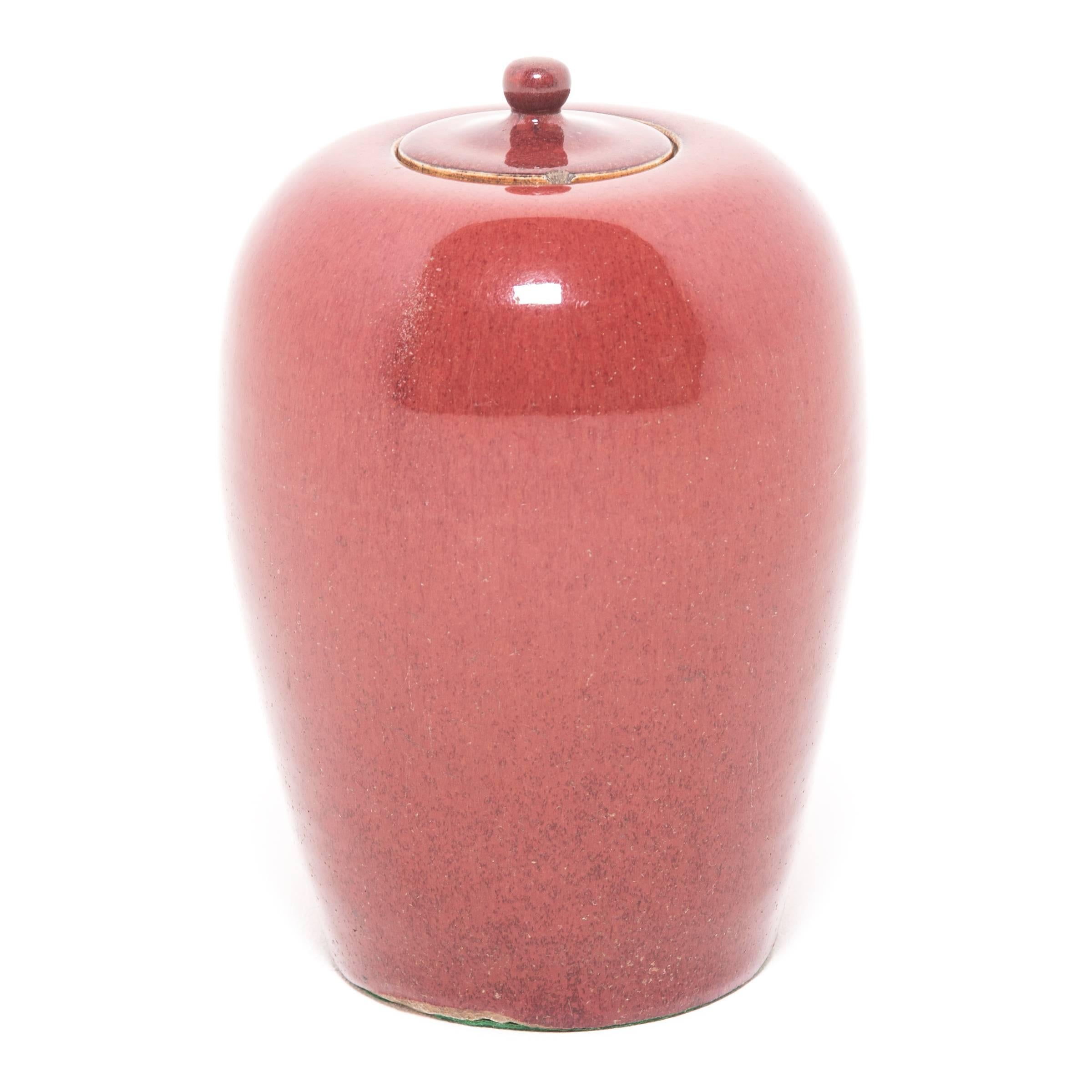 With its rounded body and high shoulders, this tall ginger jar is the perfect canvas for its rich, peach blossom glaze. For many Qing-dynasty elite, peach blossom was a preferred finish to fine ceramics for its resemblance to sweet, ripened fruit.