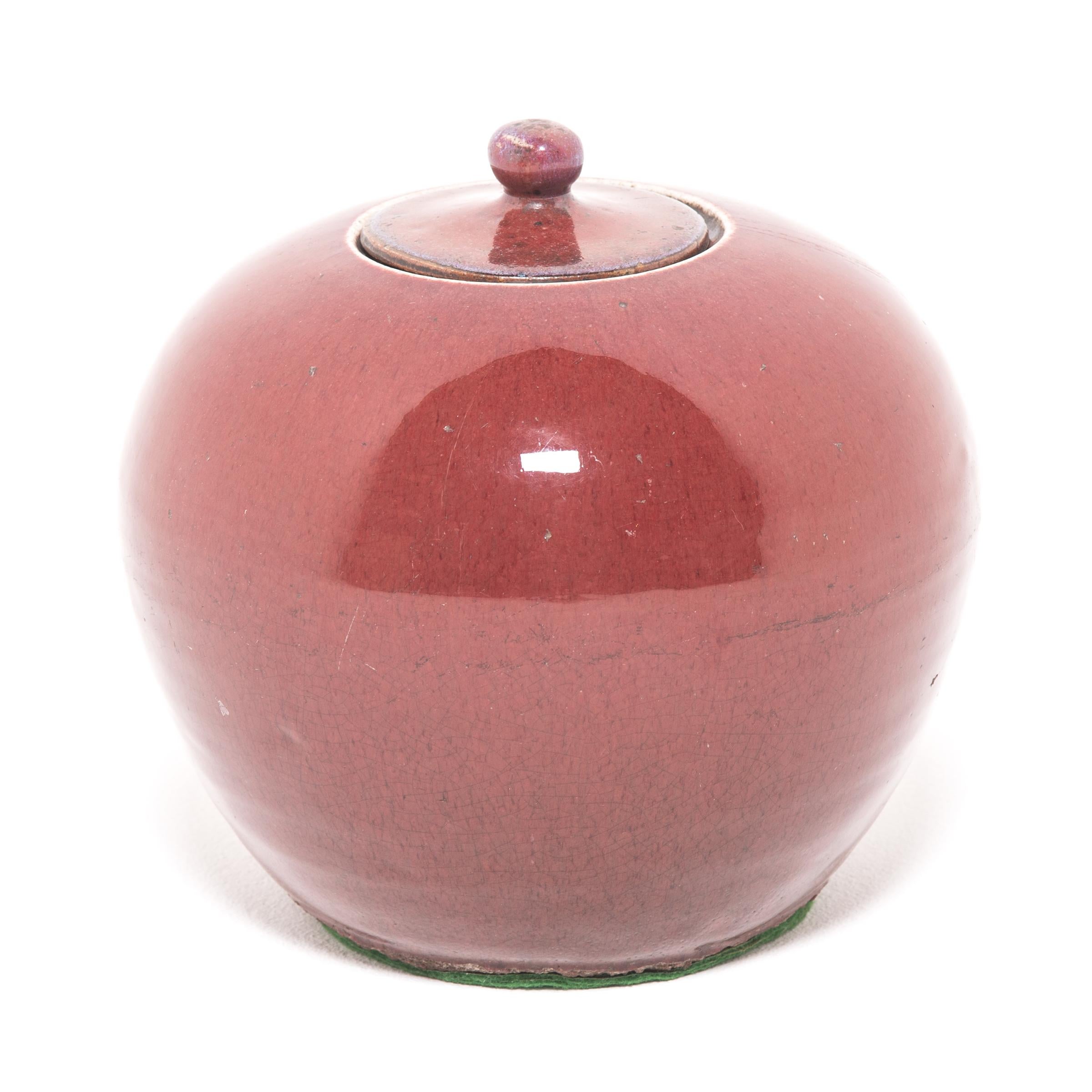 With its Classic form, this round melon jar is the perfect canvas for its rich, peach blossom glaze. For many Qing-dynasty elite, peach blossom was a preferred finish to fine ceramics for its resemblance to sweet, ripened fruit. The copper-based