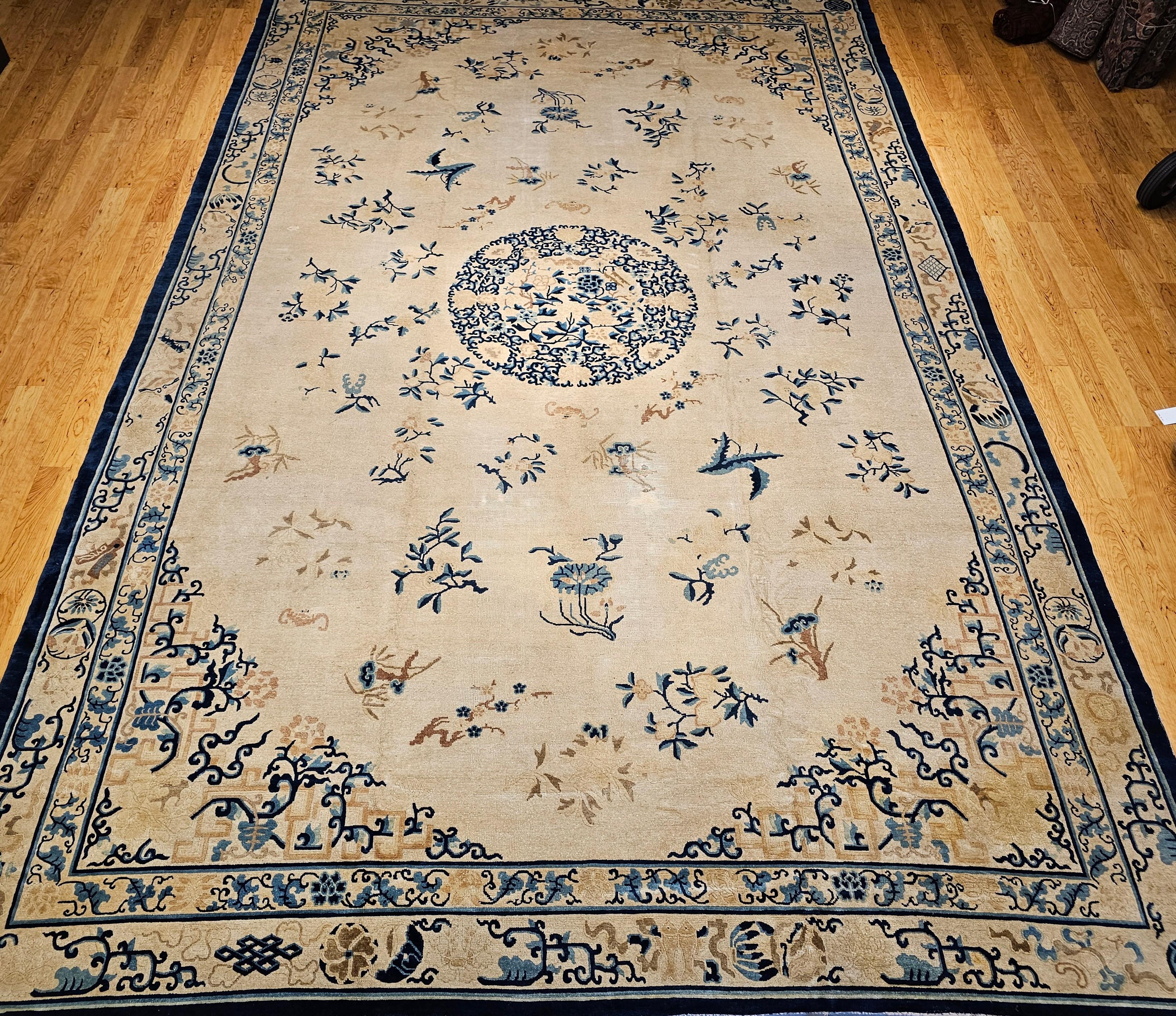 An exquisite 19th-century oversized Chinese Peking rug, showcasing a serene ivory field paired with an elegant French blue palette. At the center lies a refined medallion, surrounded by a harmonious arrangement of traditional Chinese symbols of