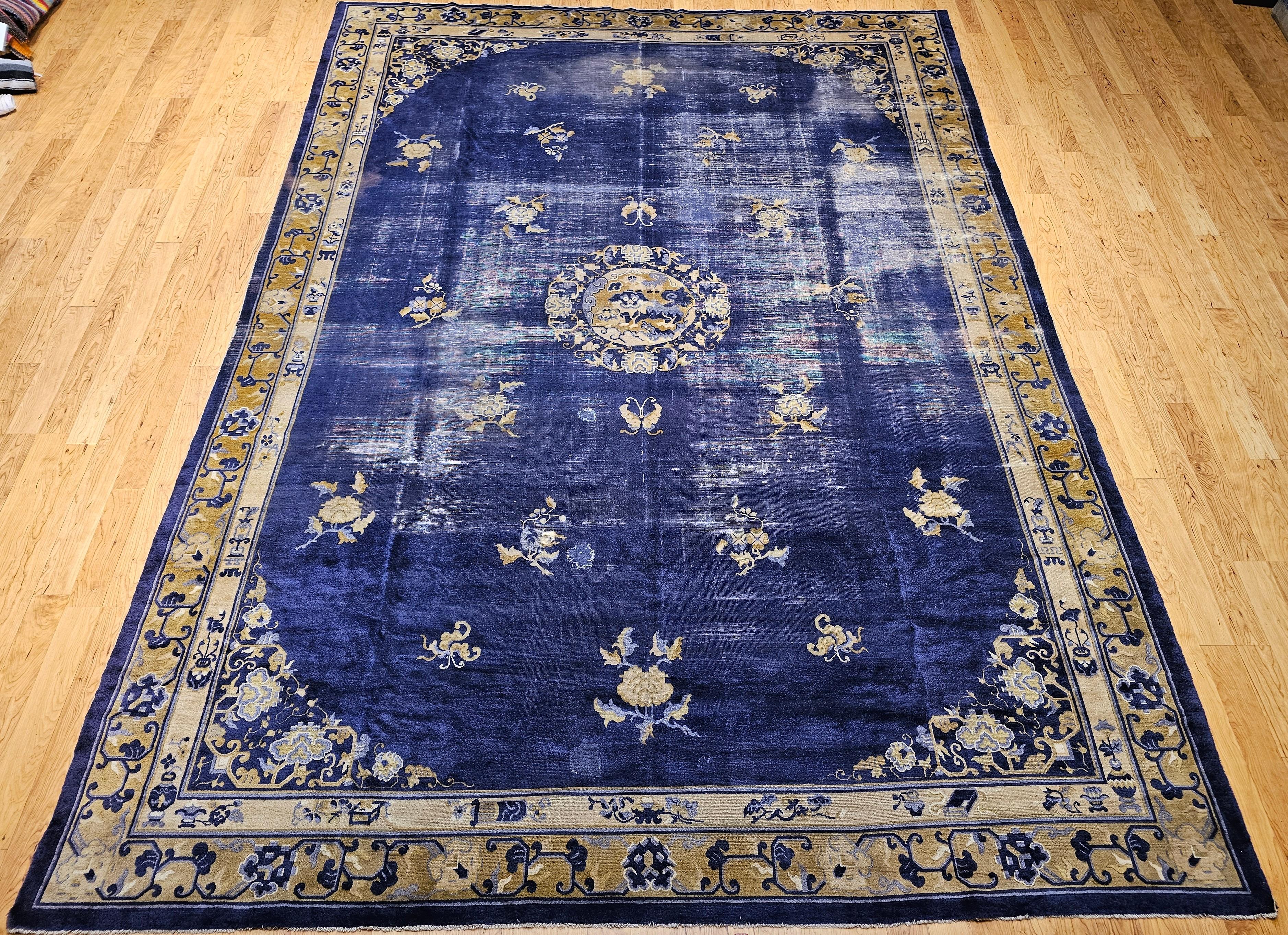 Imbued with history and cultural meaning, this 19th Century Chinese Peking rug is a masterful expression of traditional symbolism and timeless design. Handwoven in rich indigo wool, this room-size rug features a captivating array of auspicious and