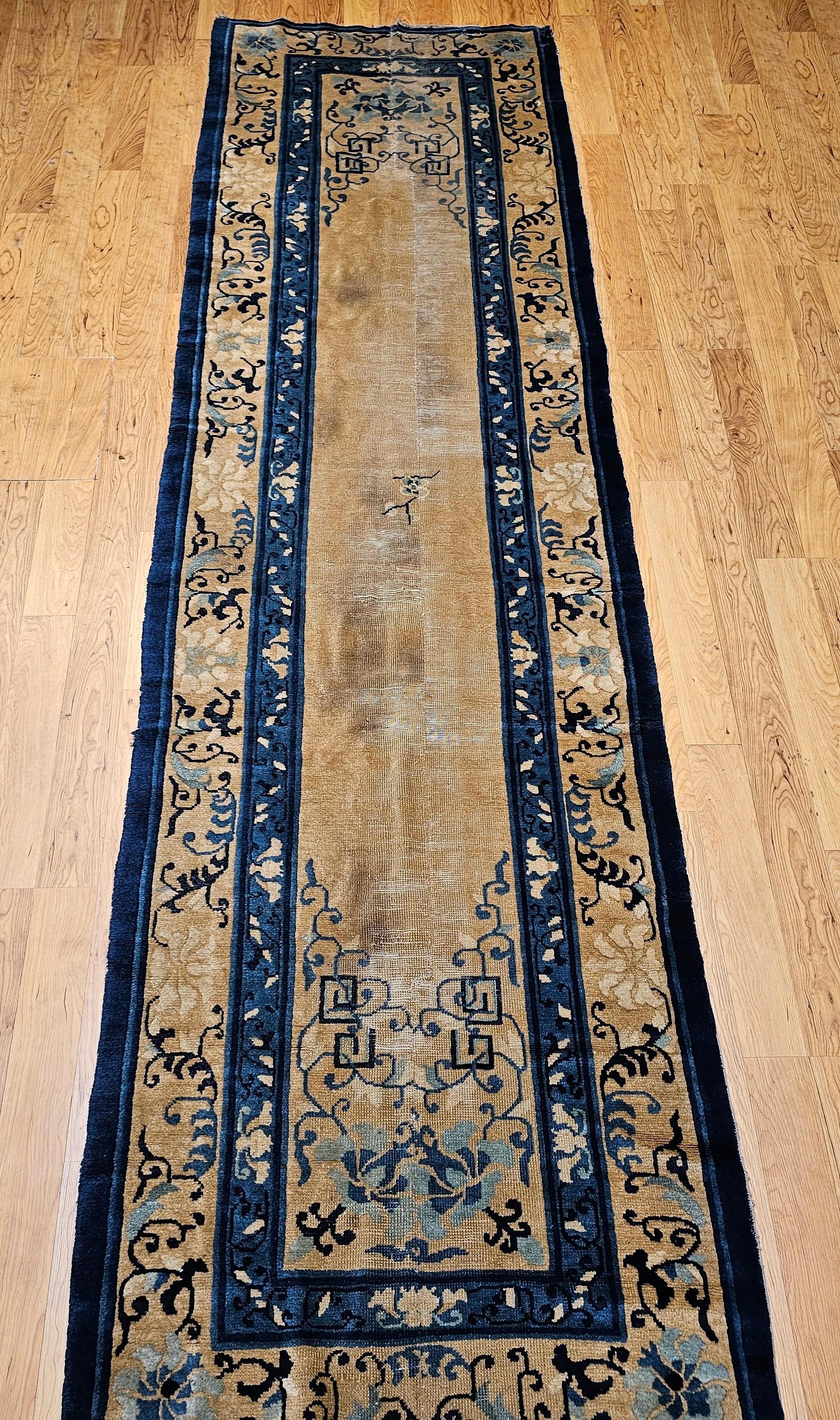 Rehaussez votre espace avec cet exquis chemin de table chinois antique de Pékin, un textile rare et raffiné datant de la fin des années 1800. Présentant une palette de couleurs ivoire et bleue intemporelle, ce tapis en laine noué à la main incarne