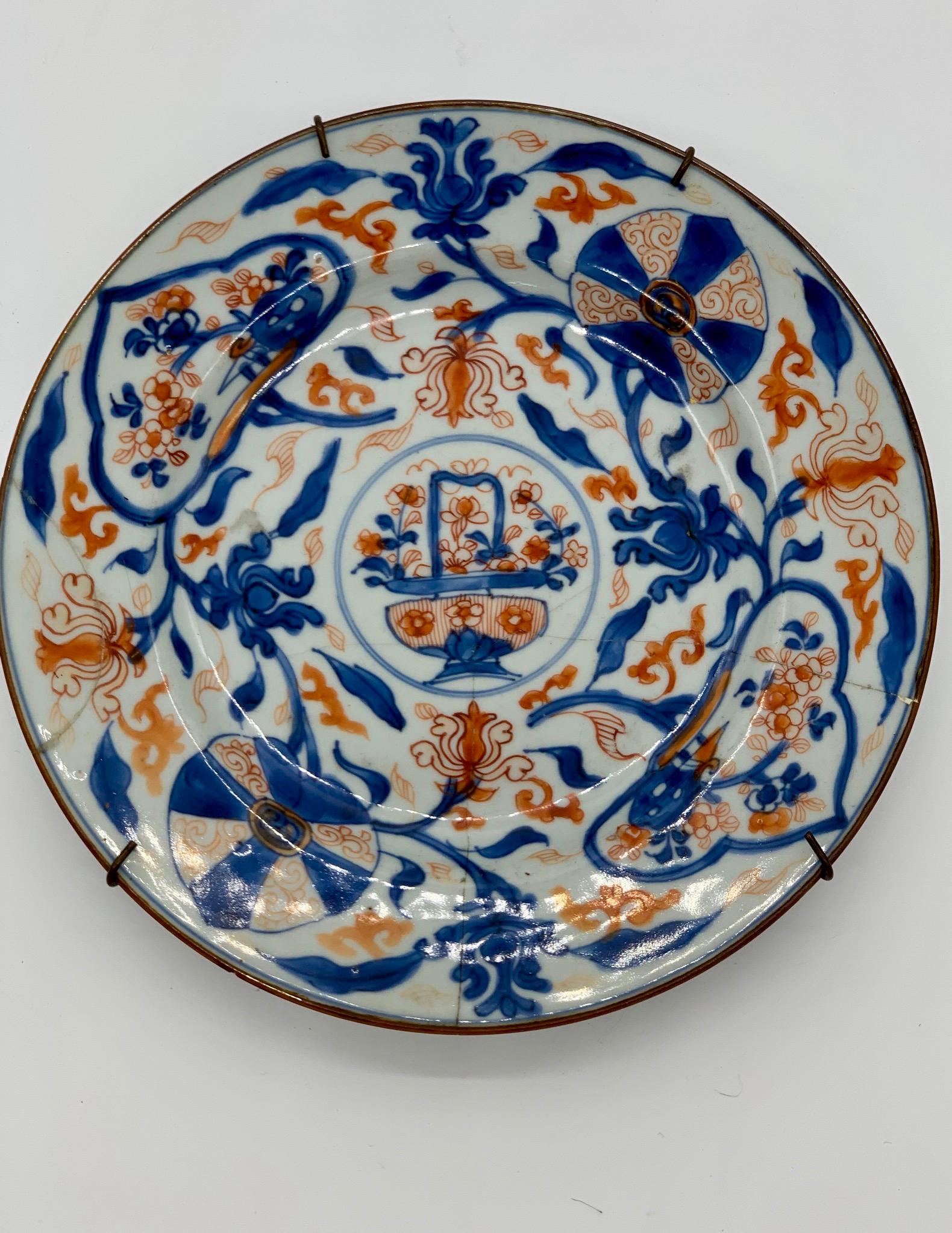 This Chinese decorative plate shows mango leaves and flowers in blue and orange color. It has been previously fixed as can be seen in images.