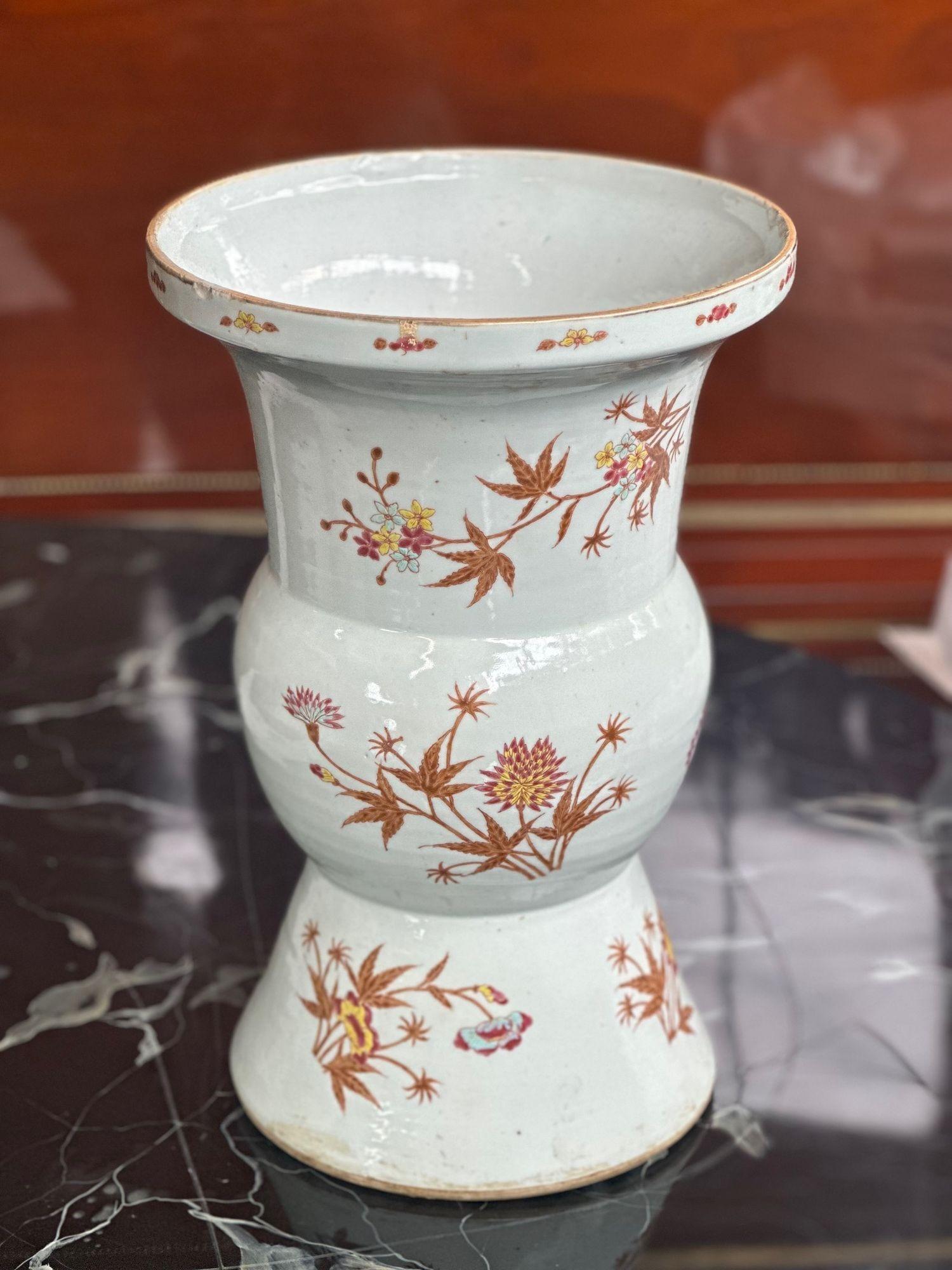 White Chinese porcelain vase in a unique form with brown, pink and yellow botanical details all around. 
Dimensions:
16