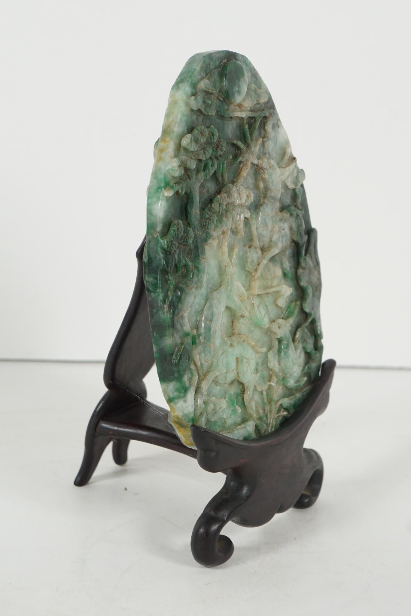 This very nice carved plaque of good size comes from China and was made circa 1900. The stone is a rich combination of dark, light and emerald green. Sliced from a boulder washed and tumbled in a river the plaque is carved to both sides and rests