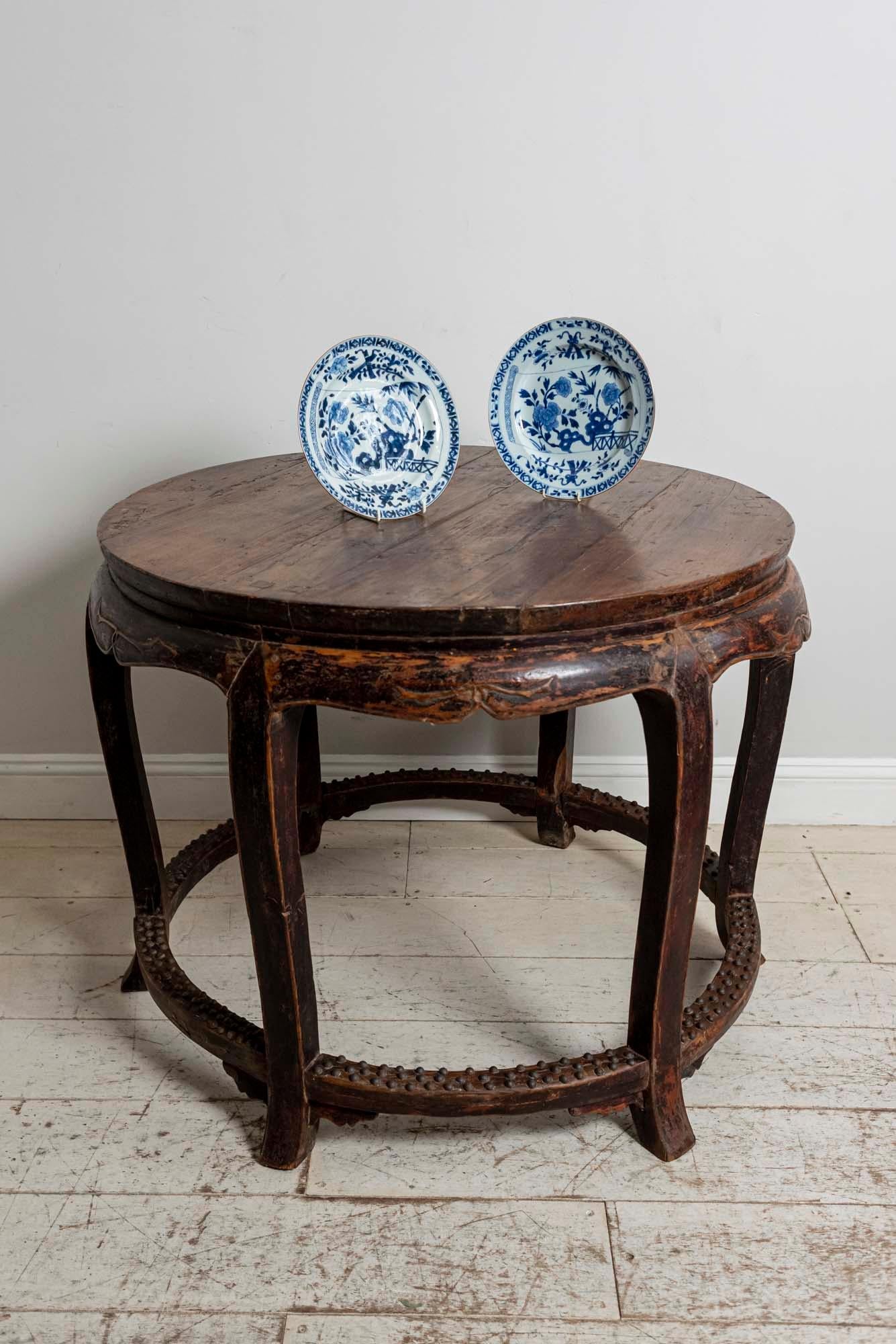 Chinese Qing Dynasty hardwood centre round table,
circa 1820, this handsome table has a solid top with a shaped apron, six legs and an iron studded stretcher at the base.

It is in a simple unrestored condition.