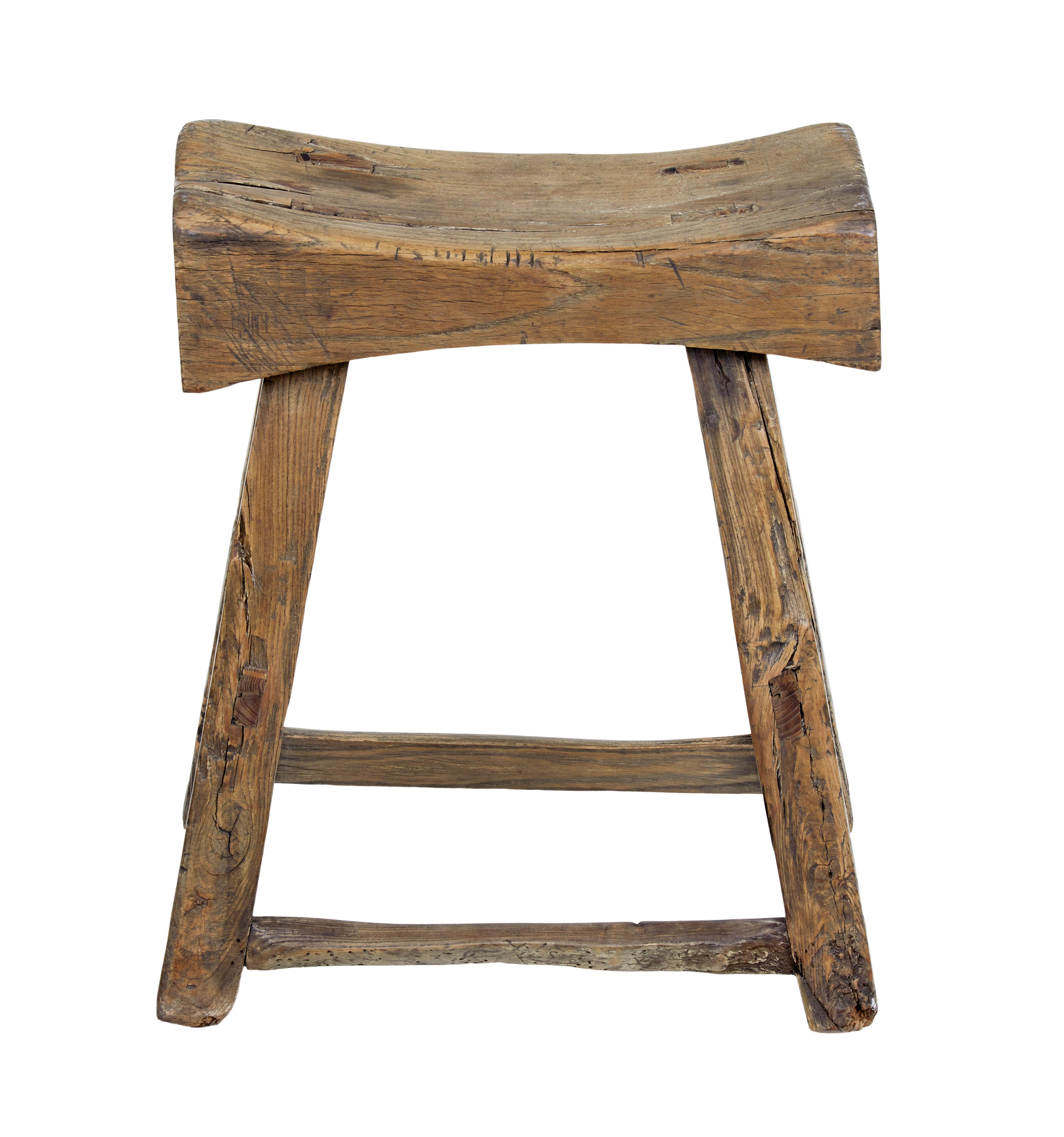 19th century chinese qing hardwood stool circa 1870.

Carved out seat almost like a butchers block. Standing on 4 legs joined by stretchers.

Character pieces of wood with knots and splits and old restorations. Heavy item due to the dense wood
