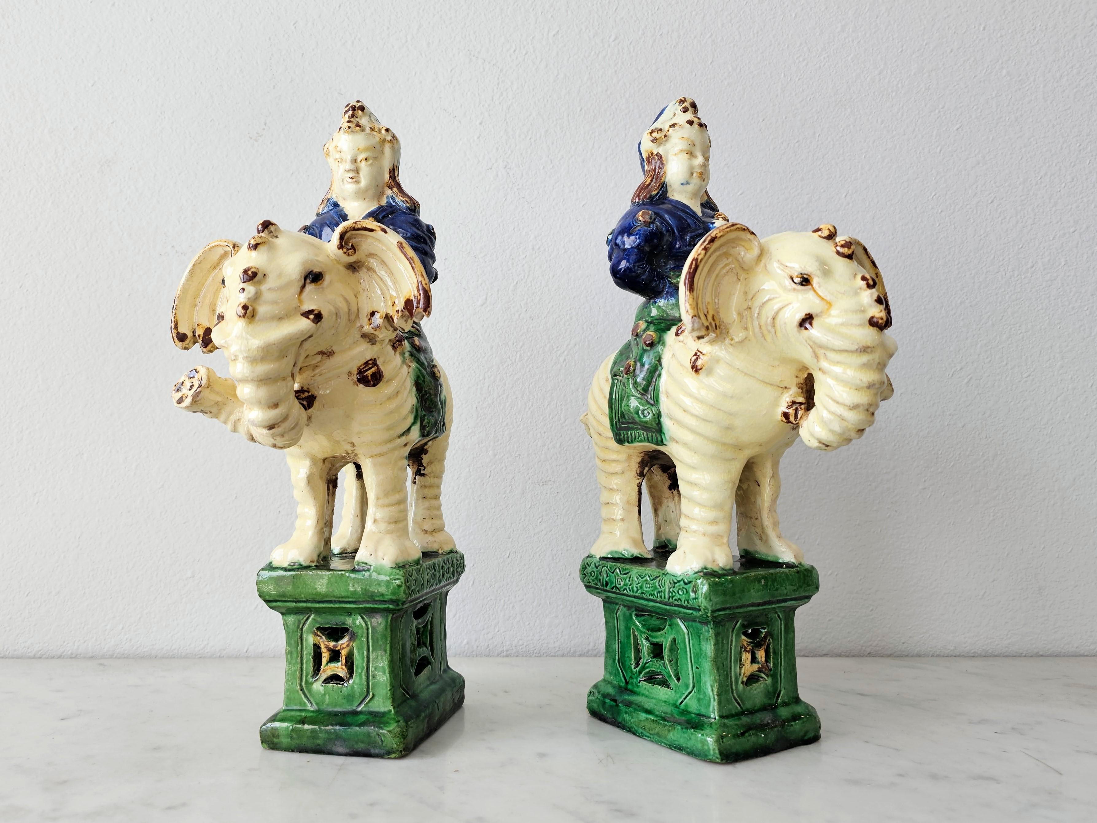 A pair of antique Qing Dynasty (1644-1912) glazed ceramic figural incense burners. 

China, 19th century, original mirrored pair, each in the sculptural form of a seated Qing warrior figure riding an elephant, polychrome decorated, rising on