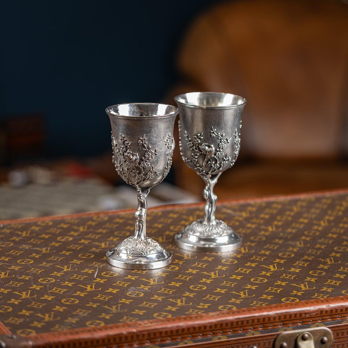 Ancienne paire de gobelets en argent massif d'exportation chinoise du XIXe siècle, d'une qualité impressionnante et exceptionnelle, ornés de fleurs de prunus et d'oiseaux exotiques perchés sur des branches, reposant sur un pied en forme de dôme et