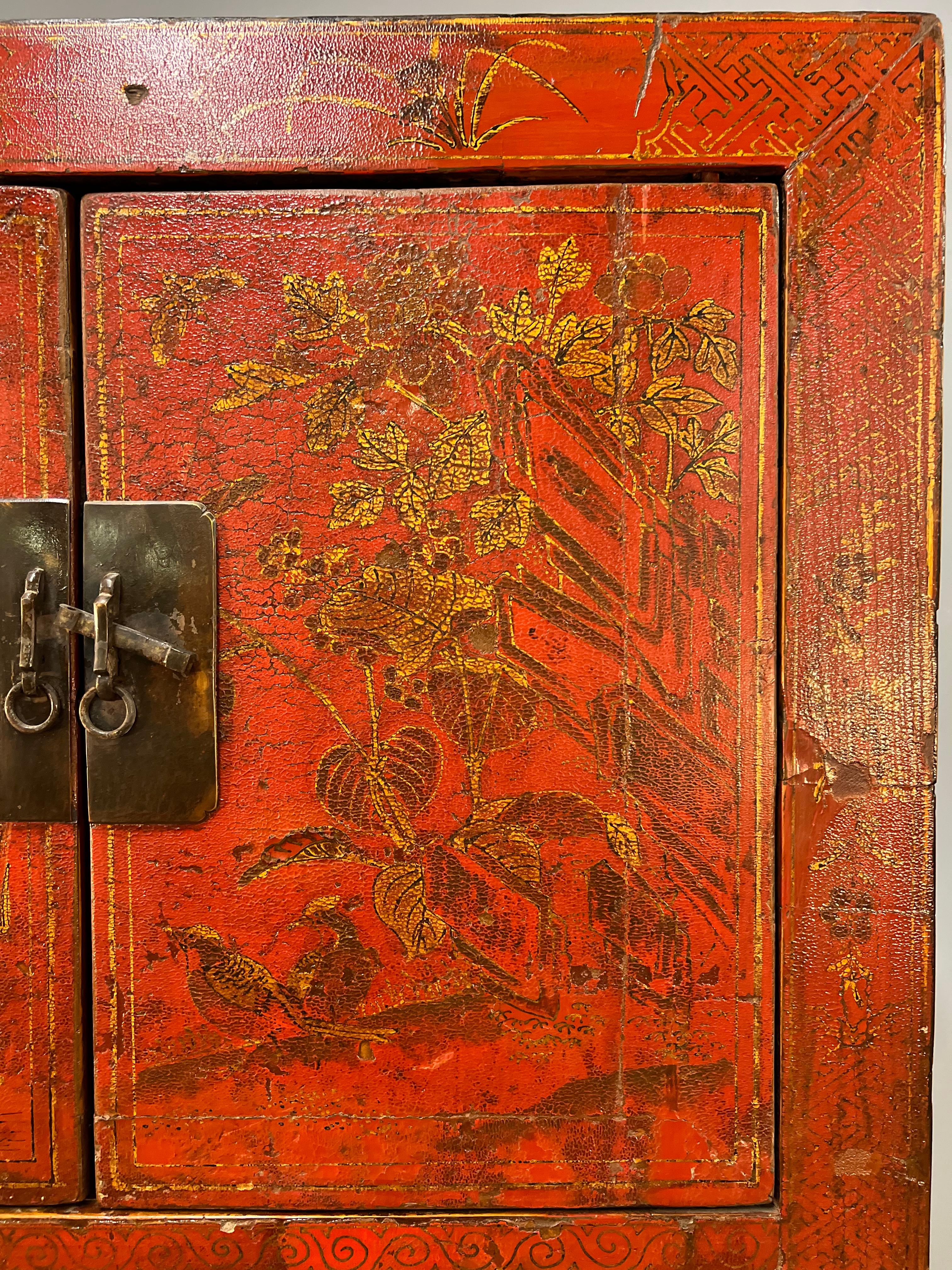 A Chinese red lacquered cabinet with gilt decoration from the late 19th century. 
This cabinet is a great size and is highly decorative and useful with a lot of hidden storage space.