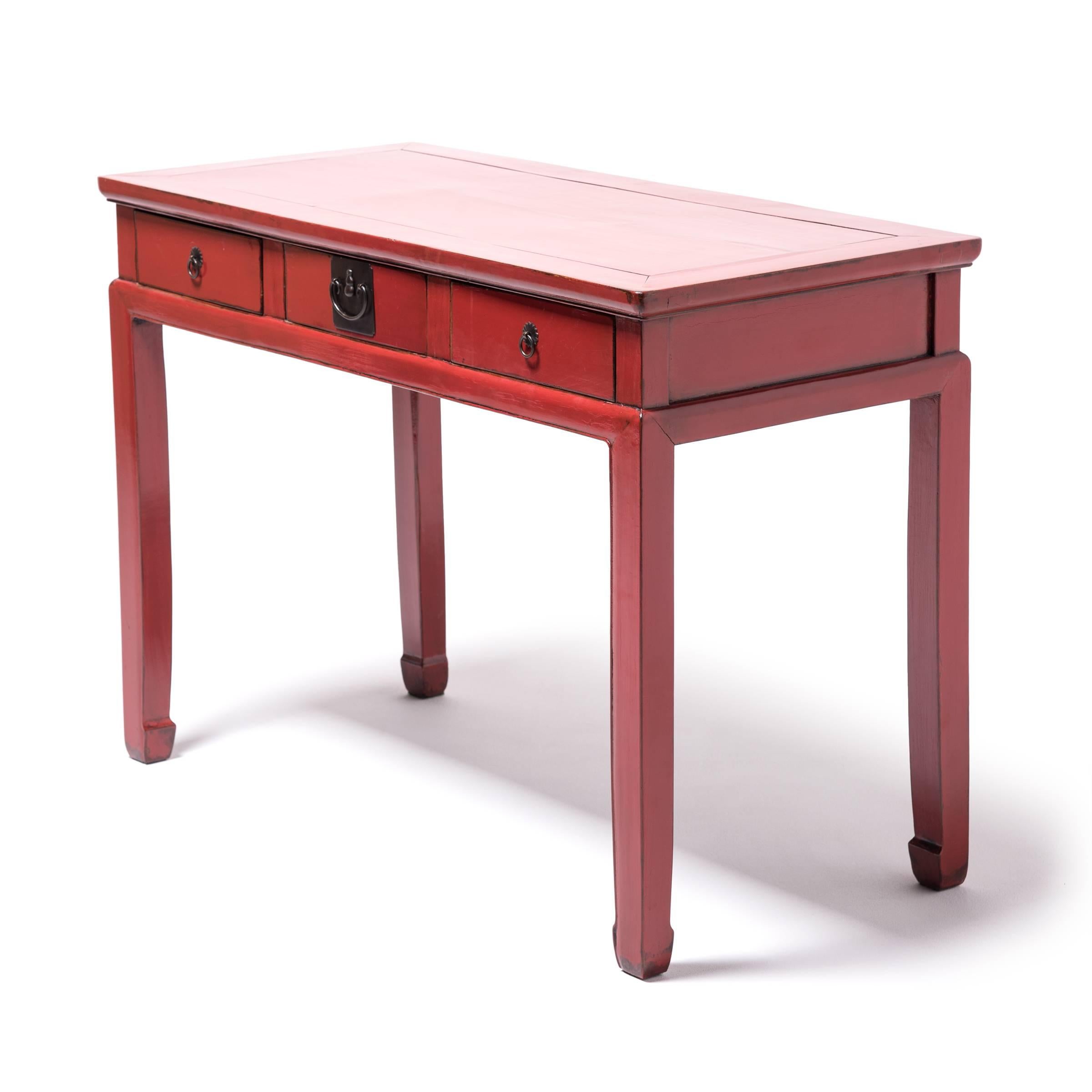 With its clean tabletop and roomy leg space, this table, modified from a 19th century design, creates the perfect space for your laptop, writing letters or greeting visitors in the foyer. Recently re-lacquered, the table revisits the vibrant red of