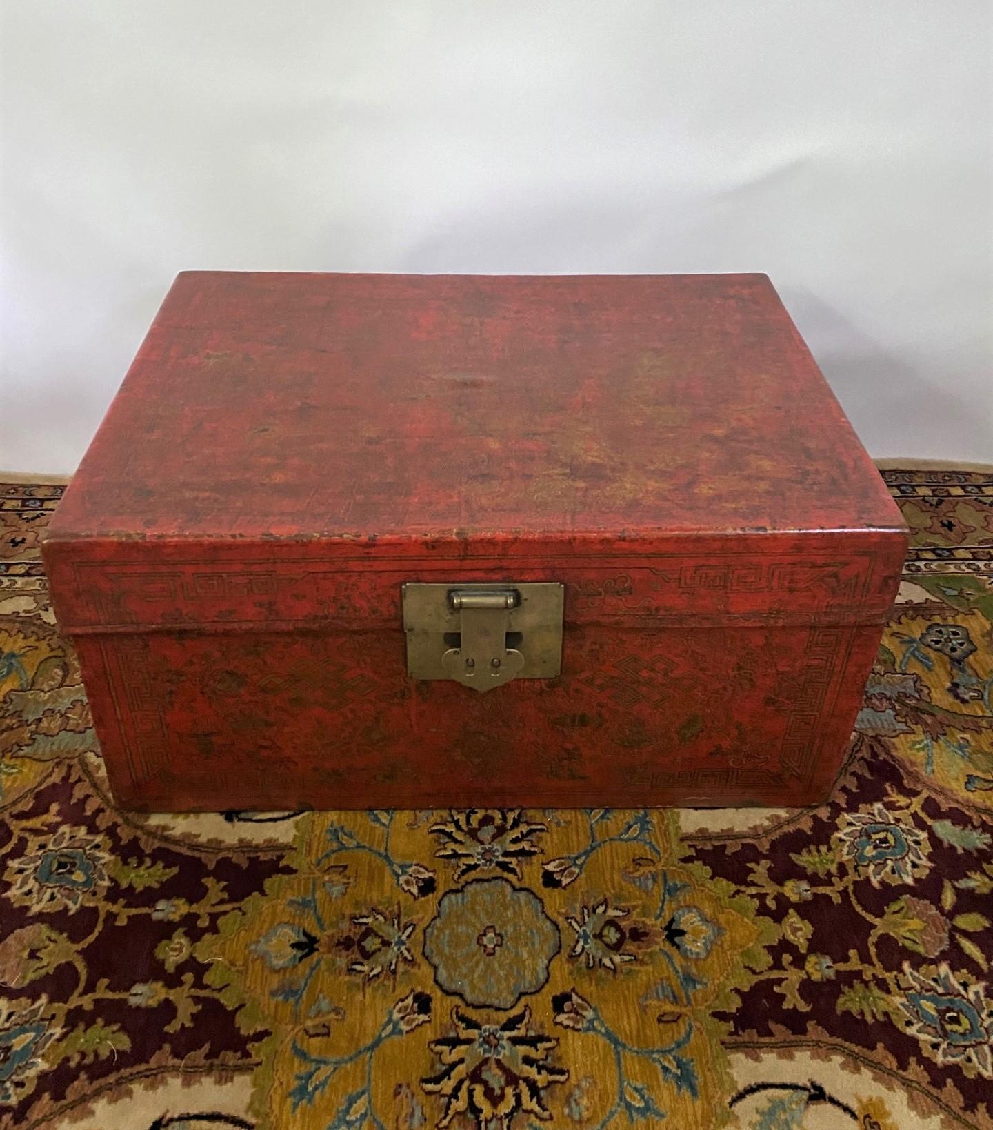 19th century Chinese lacquered leather trunk with hand-painted gold decoration and bronze handles and hardware. This attractive trunk will character to the decor and is great for storage.
