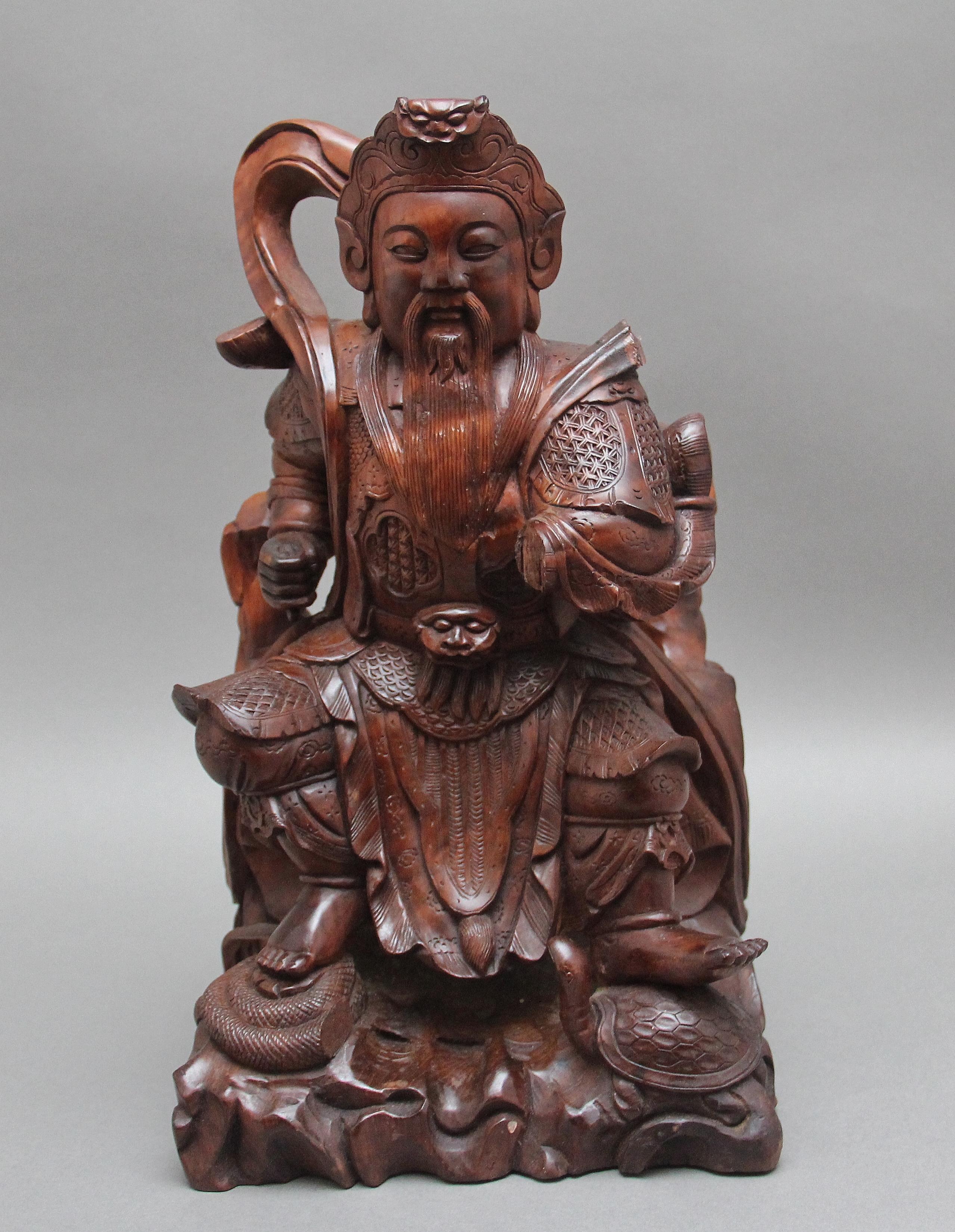 19th Century mahogany Chinese root carving of a seated ancient warrior, very detailed and nicely carved.  Circa 1880.  Damage to left arm and back of the figure.