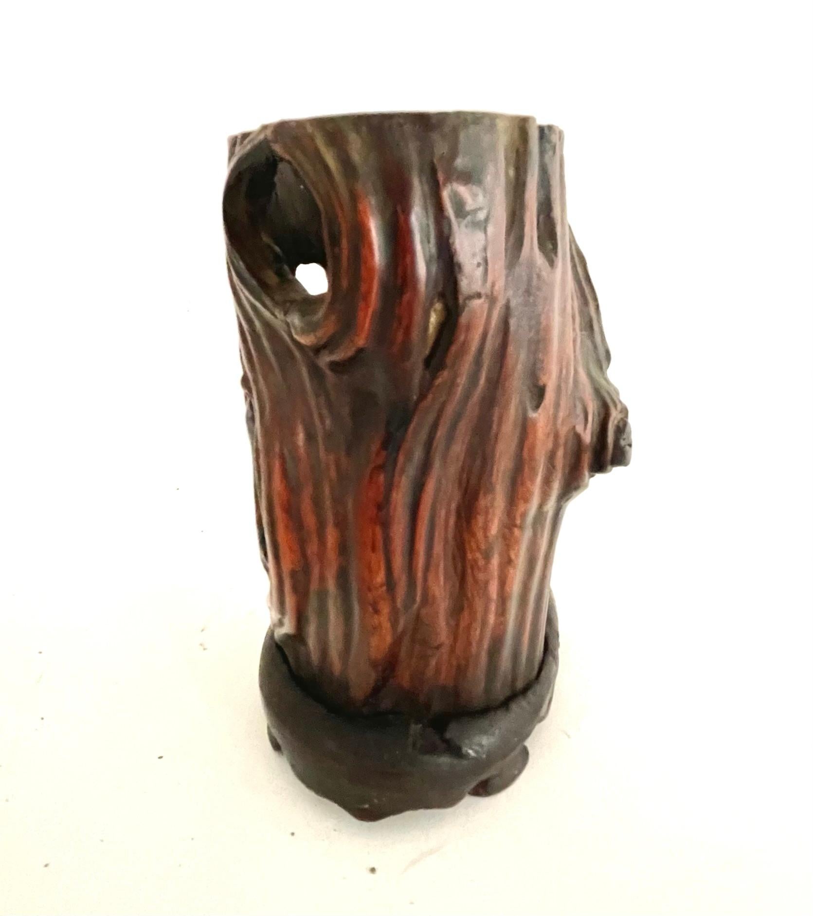 This is a beautiful 19th century Chinese brush pot made from a hardwood root. 
The root brush pot has natural gnarled surface with many knots and indents, the top edge is softly rounded, and the base is finish with a carved stand. 
The graphic