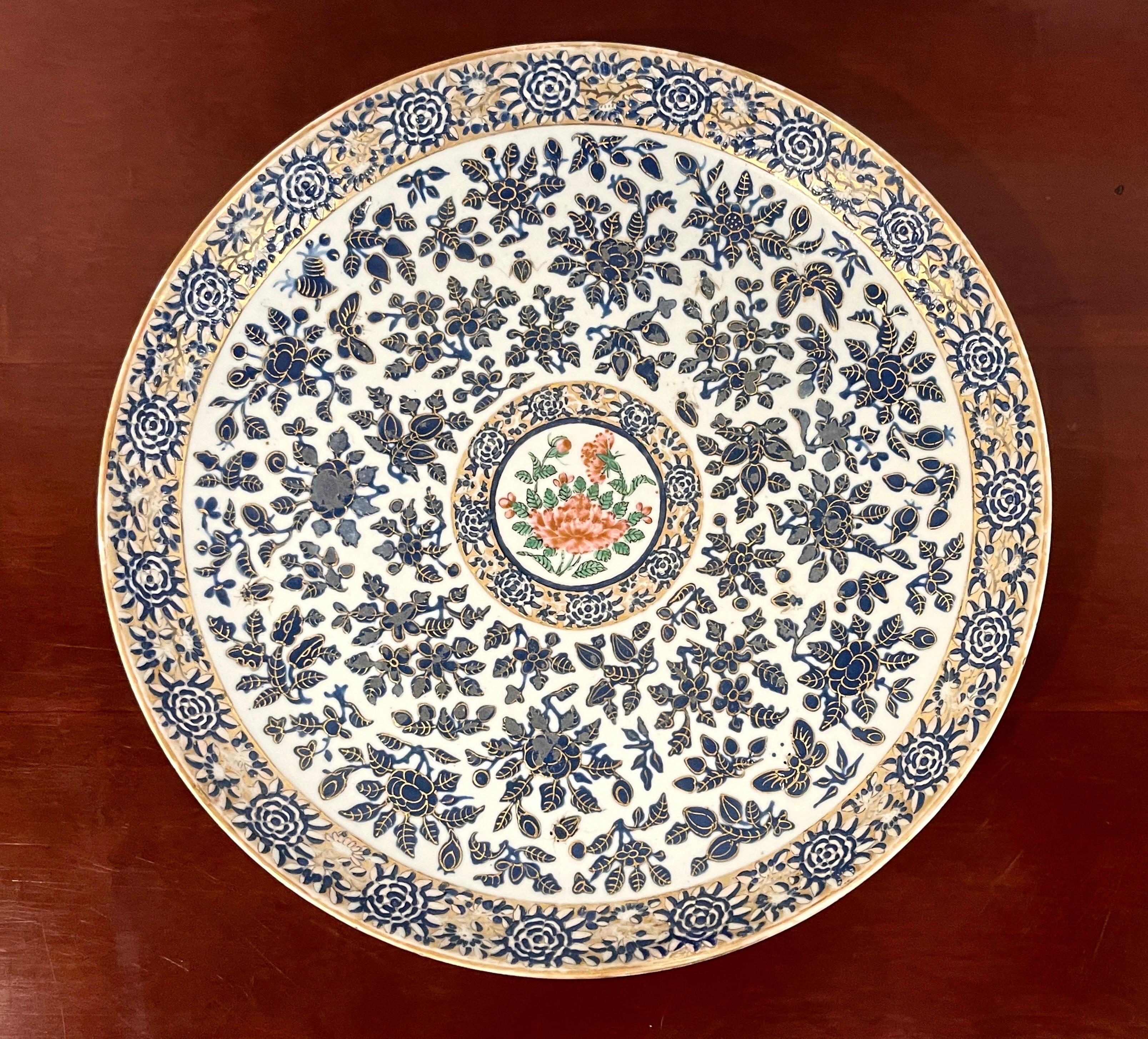 19th Century Chinese Rose Famille decorated Chrysanthemum motif charger 
China, Circa 1850s

A large and unique work with non typical continuous decoration. Of circular form with a wide decorated blue and white and gilt Chrysanthemum border, the