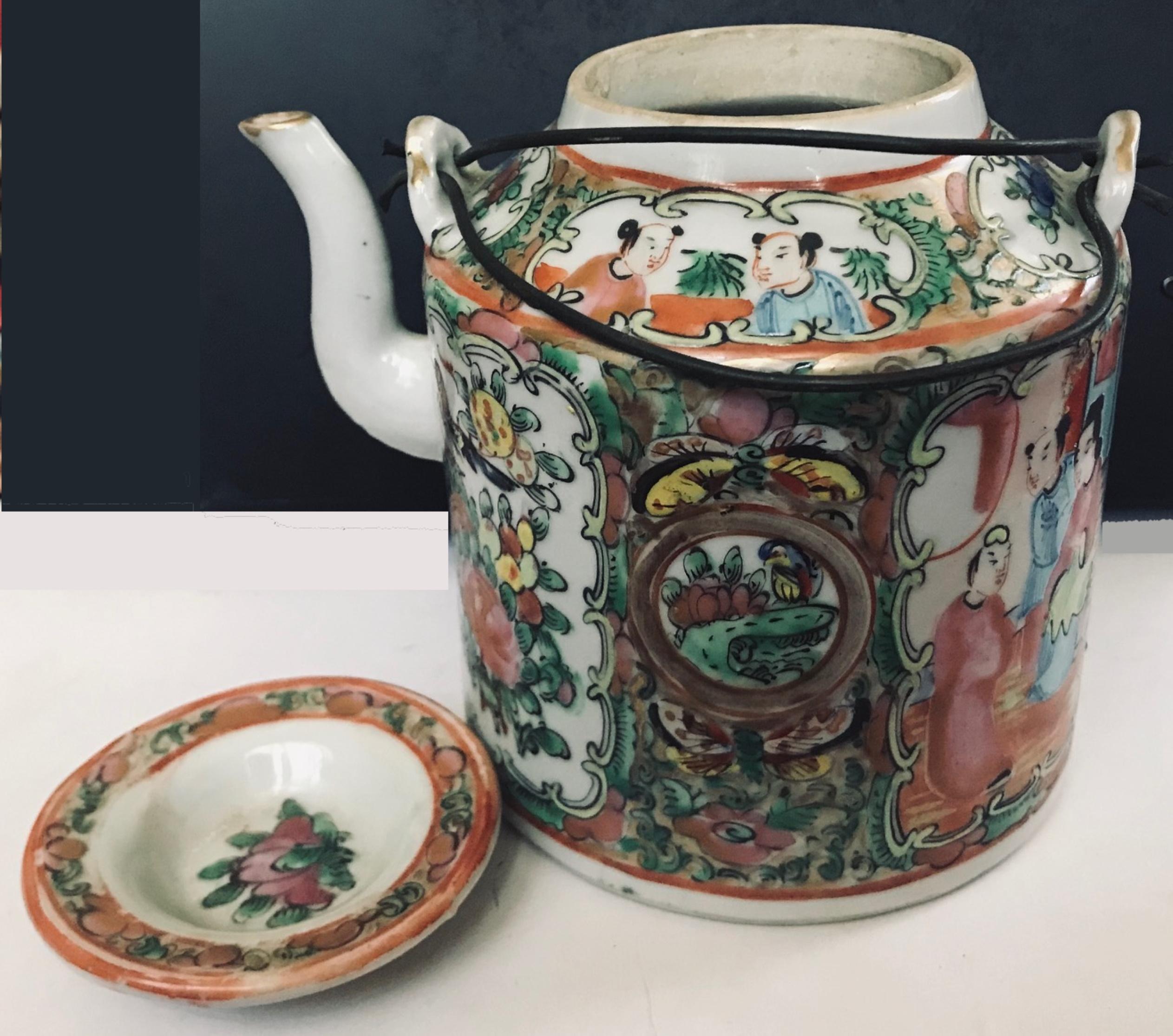 Antique Chinese Porcelain teapot with wire handles, Qing Dynasty Canton Rose Medallion circa 1850.

This Chinese cylinder form teapot is in excellent condition. It has double wire handles and traditional finely painted panels. No losses, cracks or