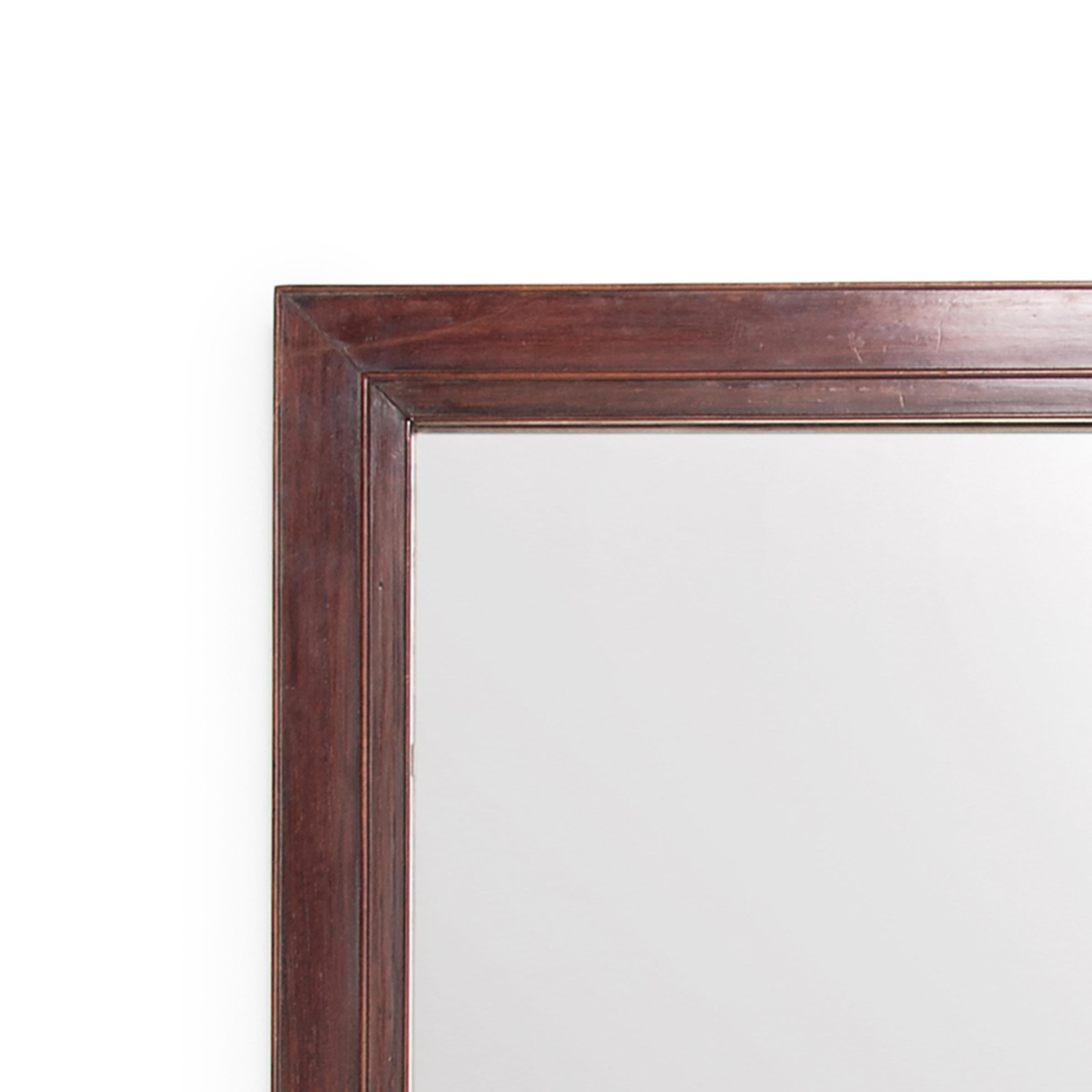 This mid-19th century Chinese scholars' mirror is crafted from a beautiful hardwood, notable for its tight grain and warm coloring. The corners are mitered and the frame is finished all around with three sinuous carved beads. A fresh mirror replaces