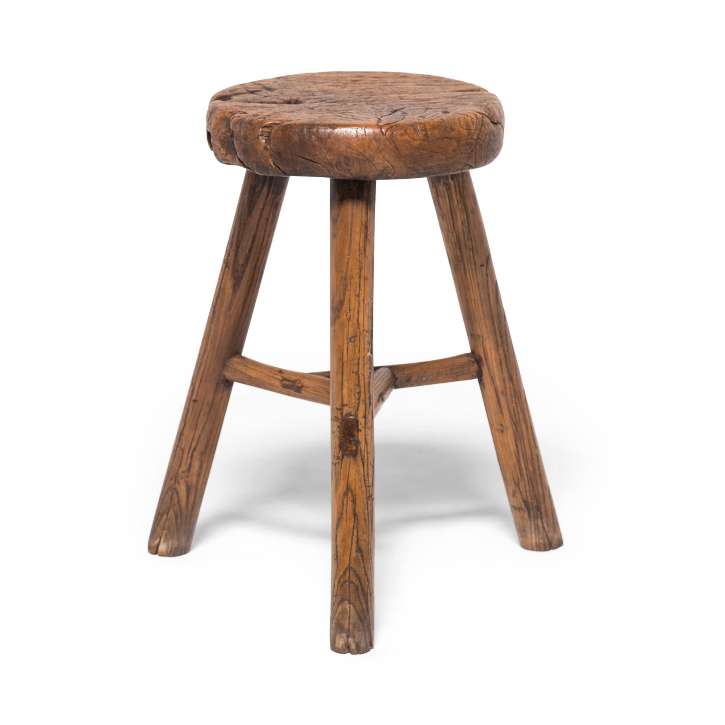This 19th century stool from China's Shanxi province charms with its simple form and fantastic texture. Its round seat beautifully showcases the expressive grain of northern Elmwood and embraces the notion of 