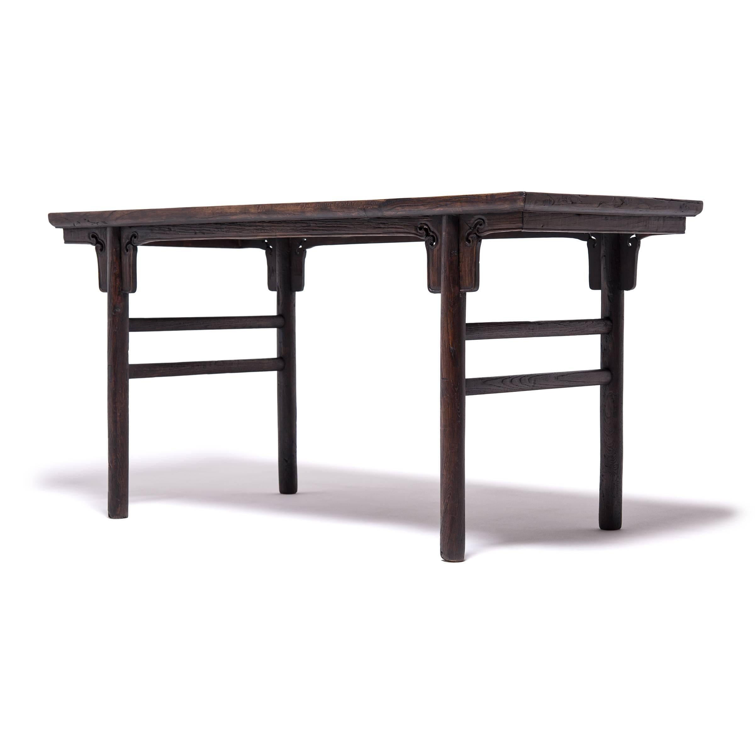 Achieving a modern aesthetic centuries in the past, this Qing-dynasty table's clean lines are at home in any contemporary room. The fundamental forms of antique Chinese furniture makeup the backbone of Minimalist design. The simple stretchers and