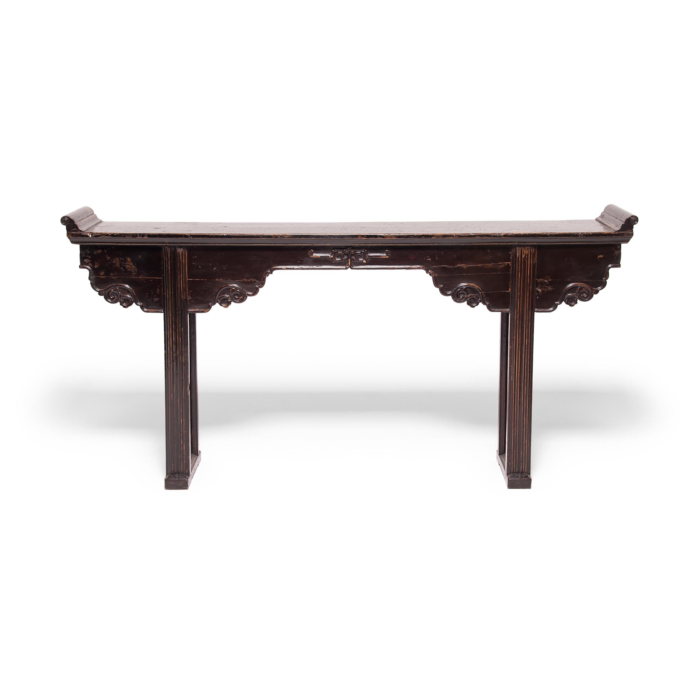 Slender, long tables like this are often referred to as “altar tables.” In ancient China they were used to hold musical instruments or display items of beauty and wealth such as jade, arrangements of flowers, or porcelain vases. This elegant elmwood