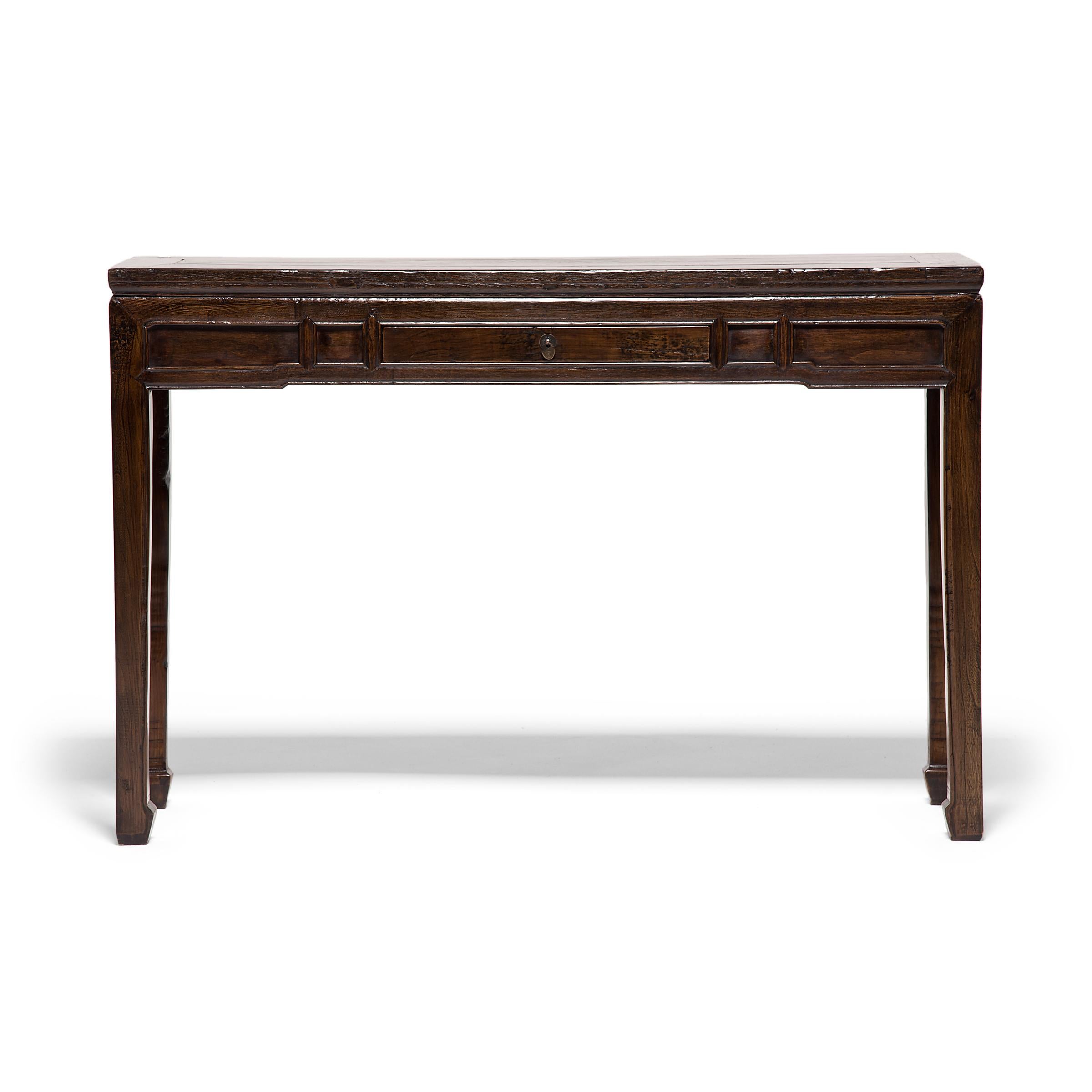 In Chinese furniture tradition, long, slender tables like such as this are known as altar tables and for centuries have been used to hold musical instruments, flowers, or precious objects. This minimal example was crafted in China's Shanxi province