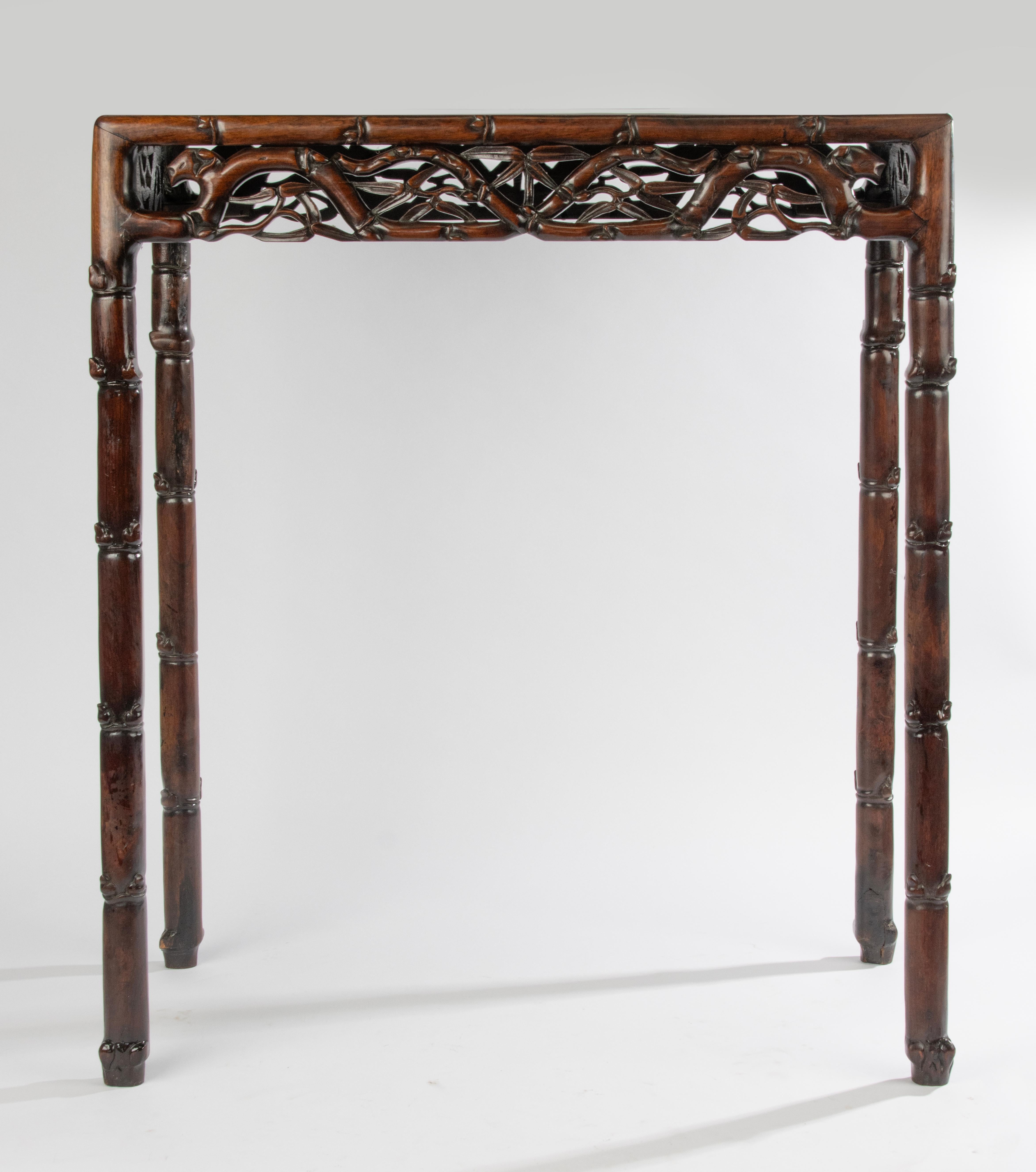 A beautiful antique Chinese Side table.
Made of Hongmu, with beautiful traditional wood carving, reminiscent of Faux Bamboo.
The table is elegant and has a beautiful warm color.
The table is in good condition.

Dimensions: 75 x 40 cm and 90 cm