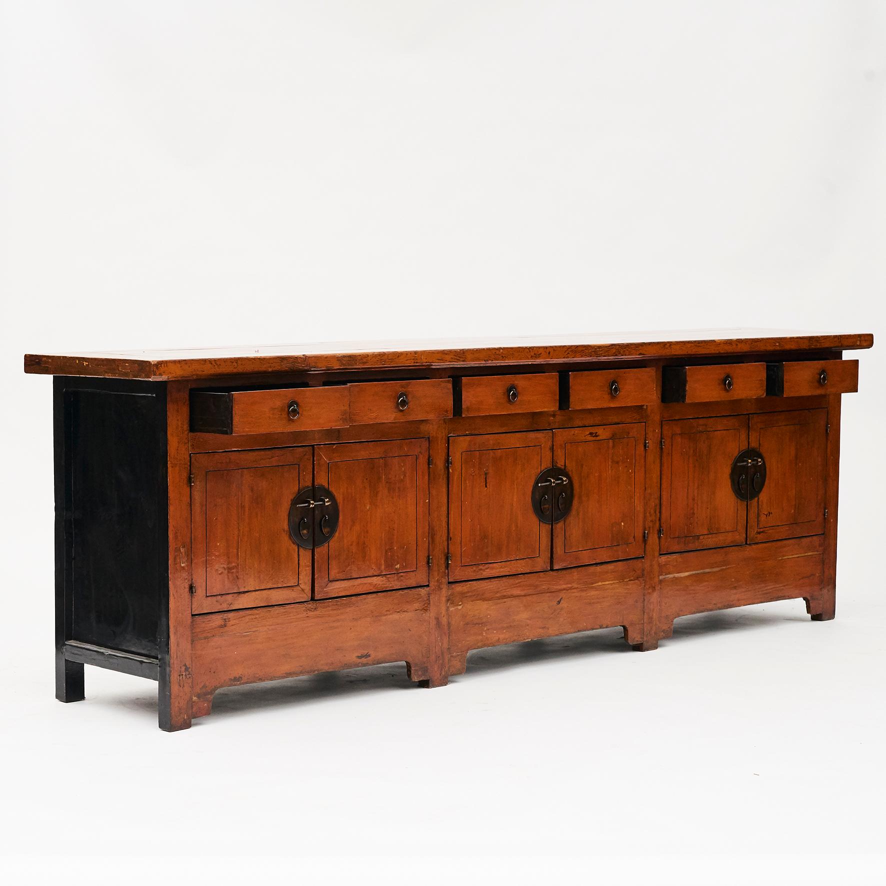 Unusually large size sideboard with beautiful original 'cayenne' color lacquer. Black lacquer on the sides. 
3 pairs of doors and 6 drawers.

From the Shanxi province, China. Dating from the early 19th century.

A beautiful and decorative piece