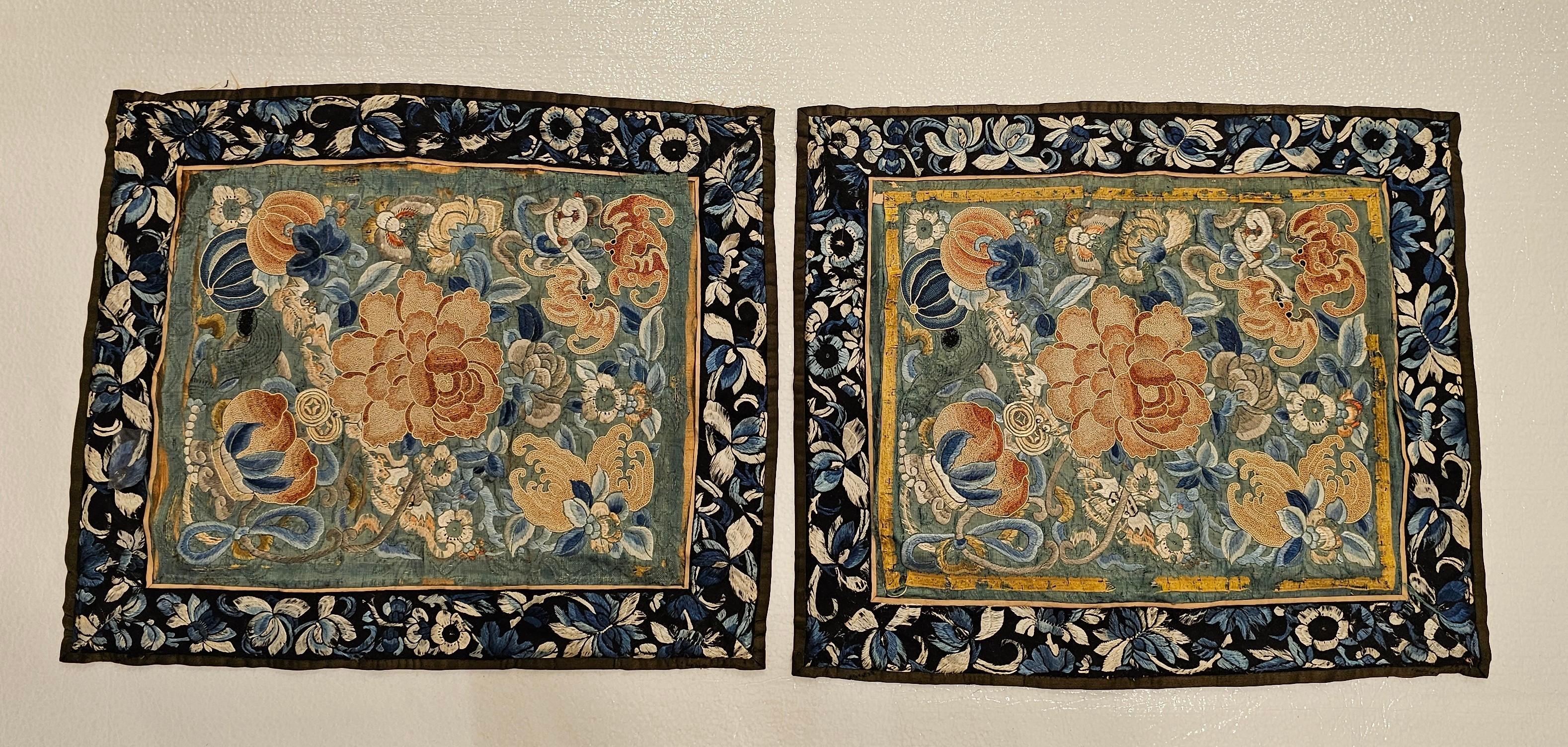 Beautiful pair of 19th Century Chinese embroidery panels.  Each panel has extremely fine hand embroidery of flowers, bats, and moths on a green silk background,  Each Panel has a wonderful embroidered order in blue and ivory.  The panels are in