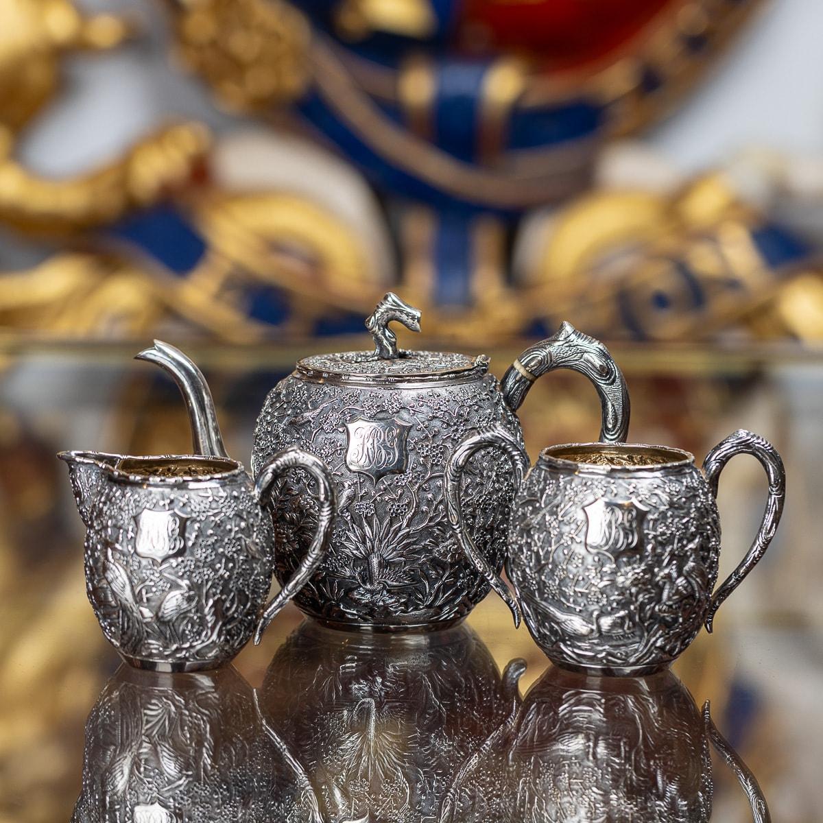 Antique late 19th Century Chinese export solid silver exquisite three piece tea set, comprising of a teapot, sugar bowl and milk jug, each spherical body applied with blooming cherry blossom and pirching birds in high relief on matted ground, teapot
