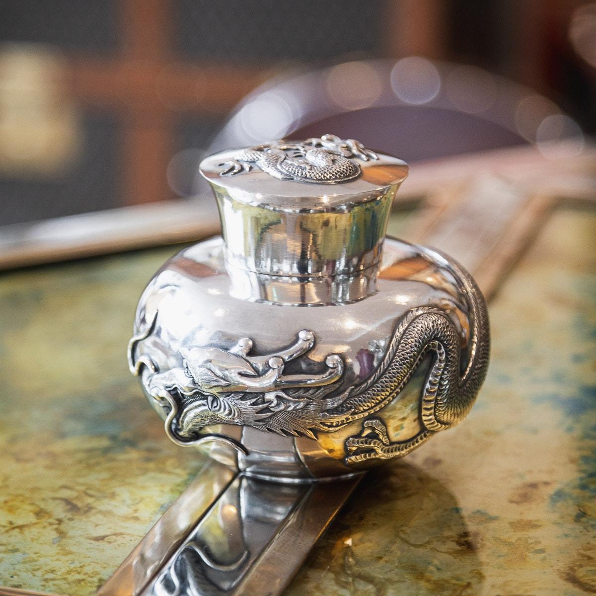Antique 19th century Chinese solid silver tea caddy, well crafted and profusely embossed and applied, depicting a dragons in high relief on polished ground, fitted with a flaired pull-off lid. Hallmarked Chinese export silver, Artisan Mark, Retailer