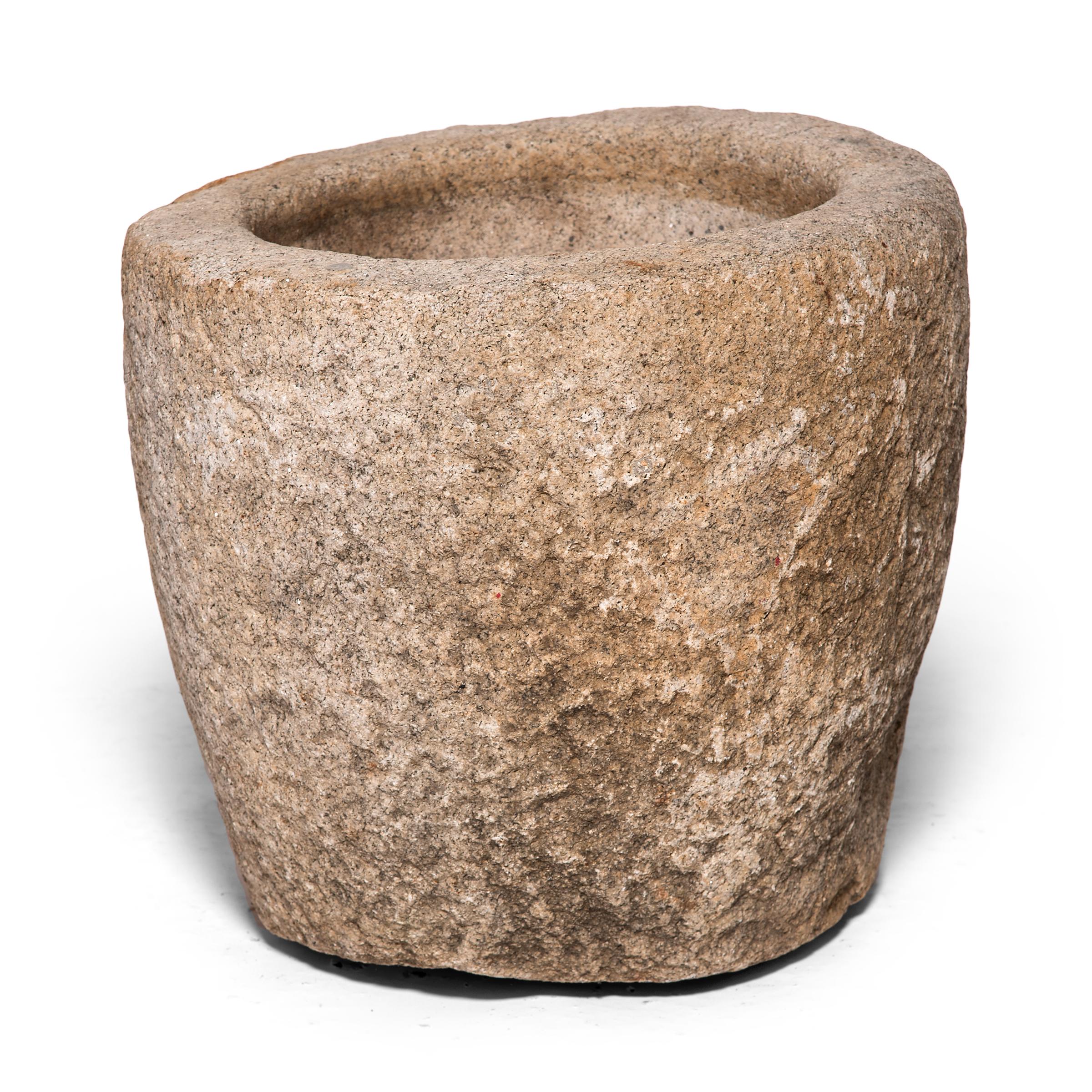This round stone vessel was hand carved from a single block of granite by a Qing-dynasty artisan in China's Shanxi province. Originally used as a grain mortar, we love the piece as a shallow planter or birdbath in a garden or patio.

Additional