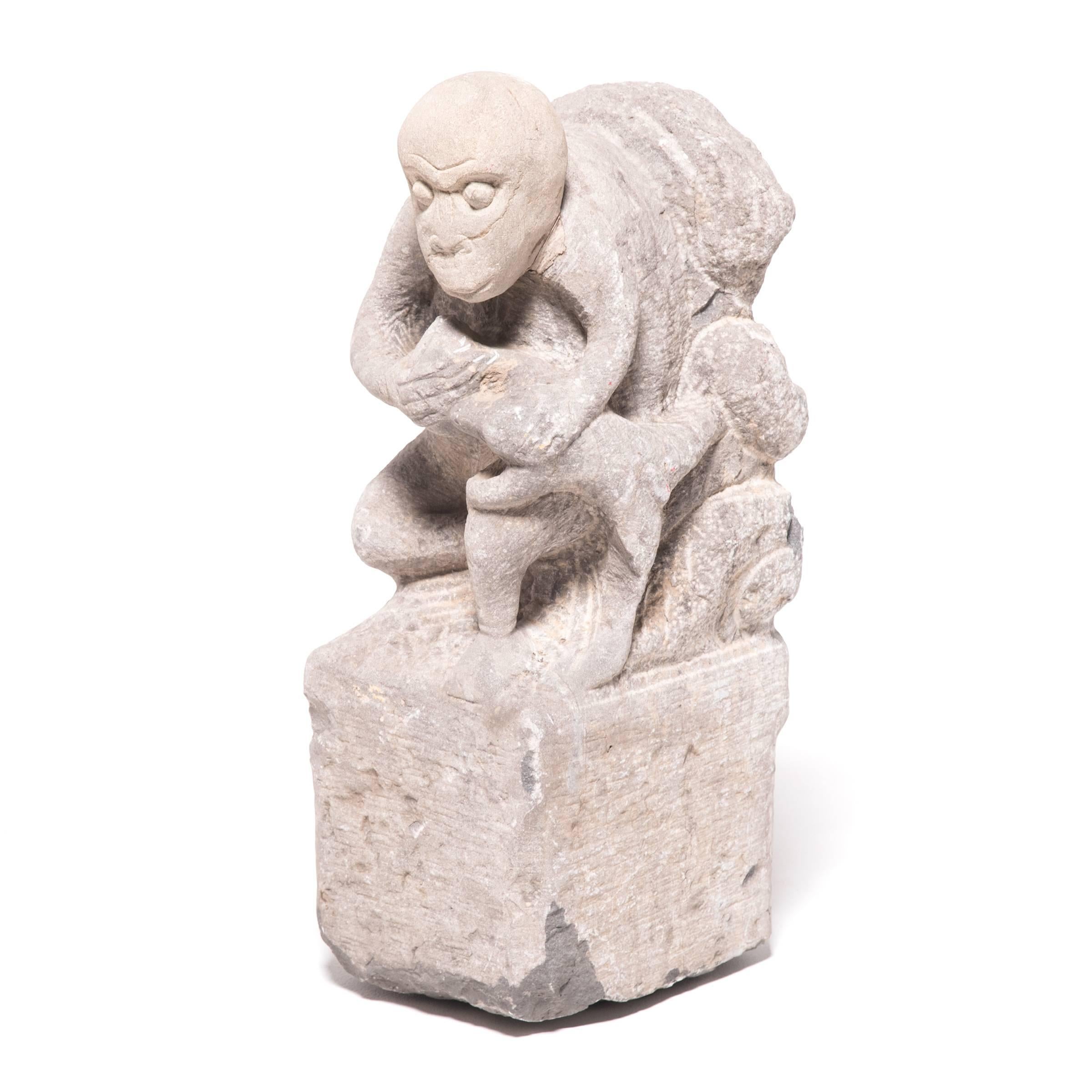 This expressive 19th century stone carving displays a kneeling monkey holding a peach. It symbolizes a wish for immortality in reference to the Ming-dynasty novel 
