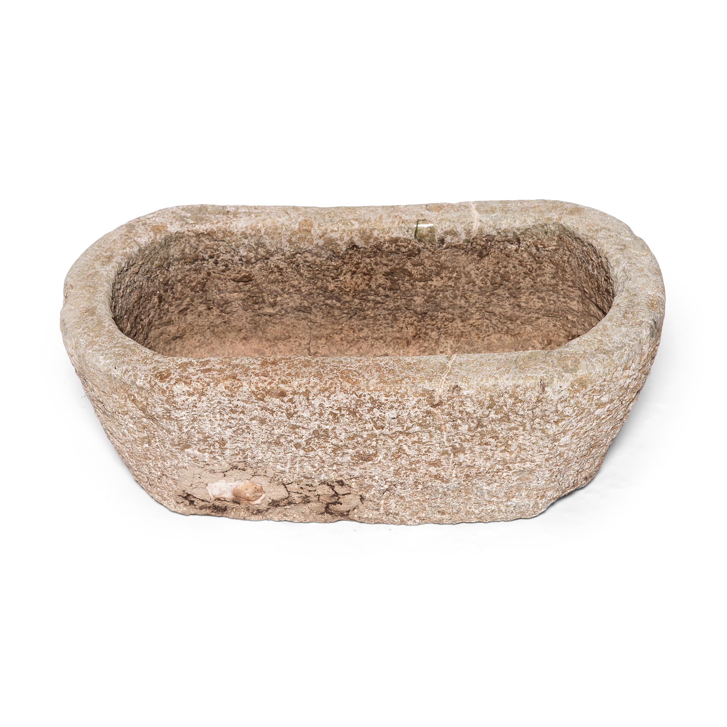 This limestone trough was made over 150 years ago in the Shanxi region of China. It was carefully carved out of a solid block of limestone by a Chinese artisan and has an elegantly simple form. The basin may once have been used as a trough on a