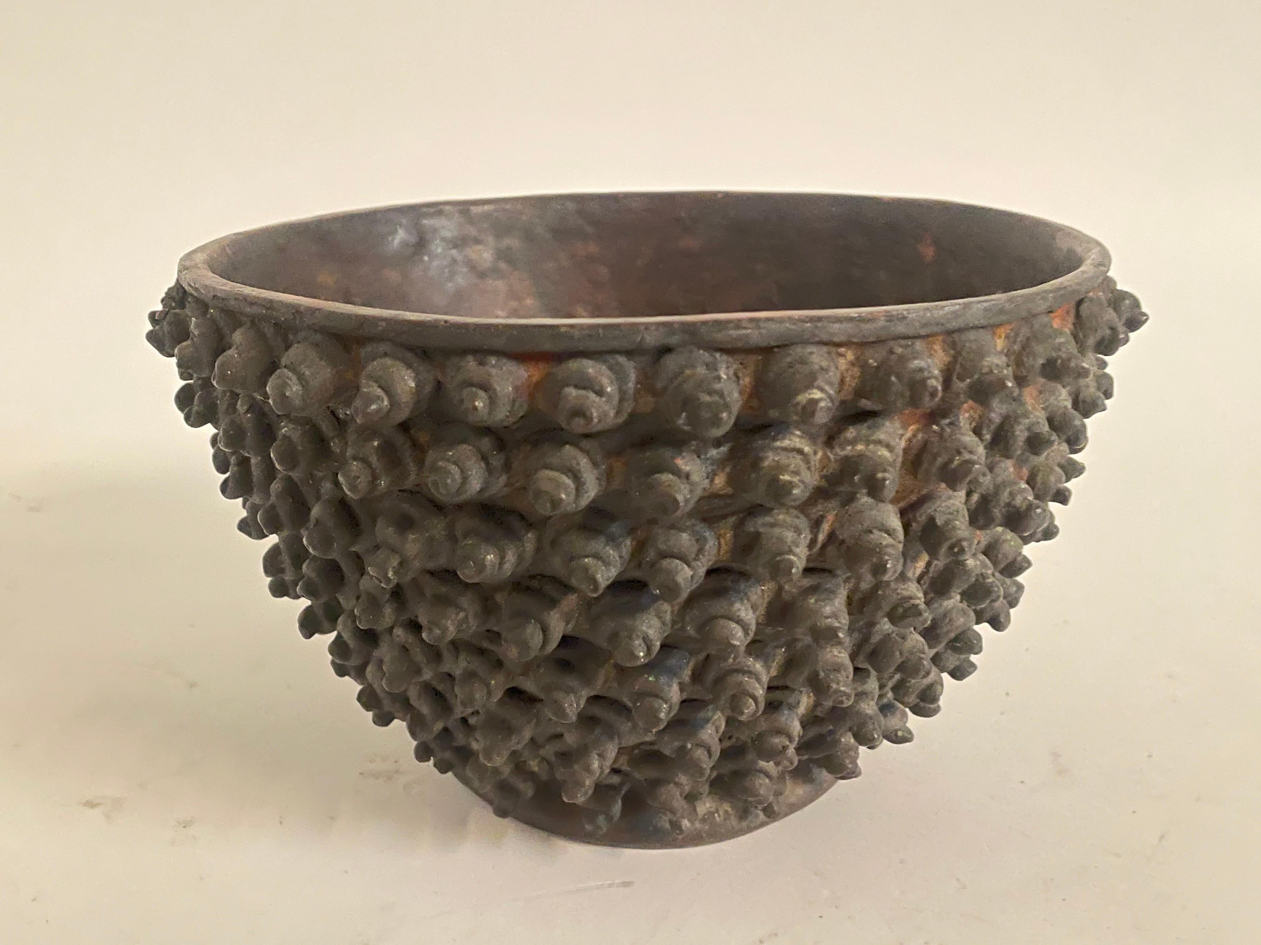 A semi-circular Chinese bronze vase, the exterior with an applied studded design. This 19th century bowl shaped vase with some verdigris and charming patination to both interior and exterior. Any UK sales are subject to VAT at 20%.
 