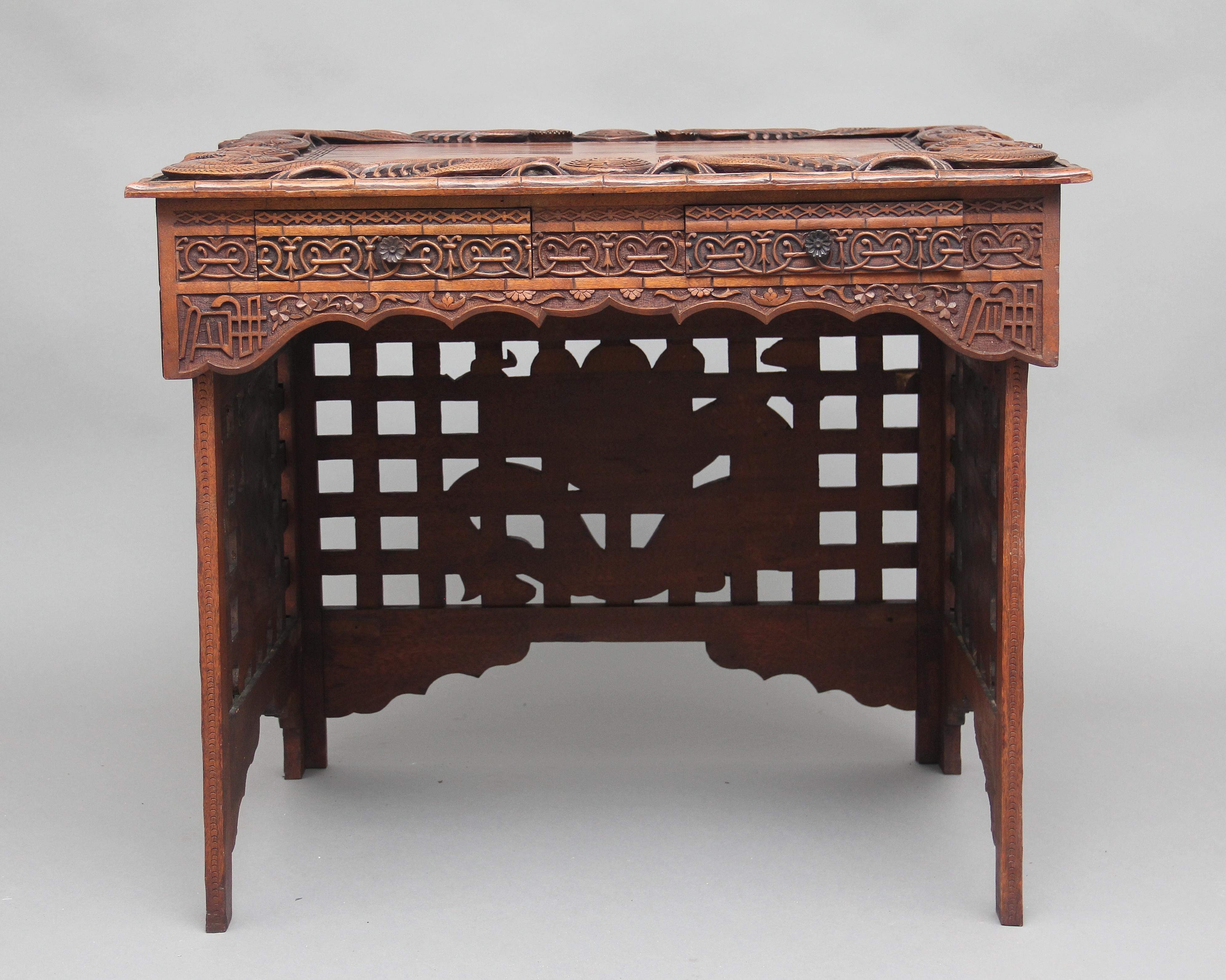 19th century Chinese traveling scribes desk, the legs fold away to make it easy to transport when they were traveling, the carving is top class, the moldings are carved to look like bamboo and it’s carved all over with mythical creatures and