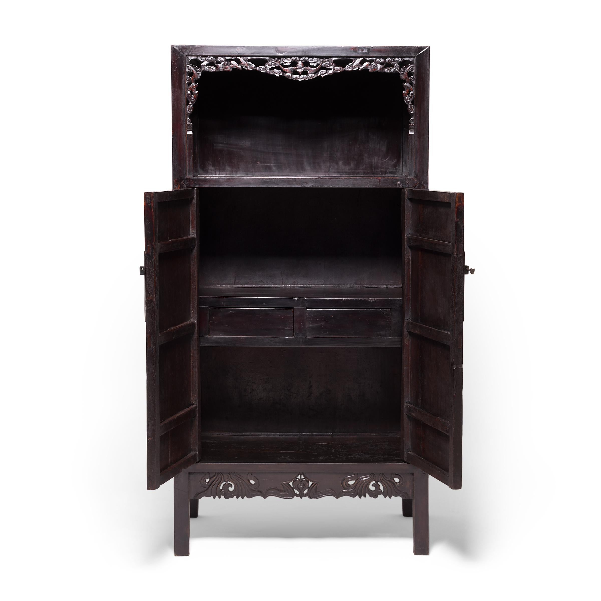 This book cabinet was likely originally commissioned for a scholar's study to store important texts. The quality and craftsmanship is clear in the bold lines, elegant hardware, and traditional mortise and tenon joinery. But, the exquisitely carved