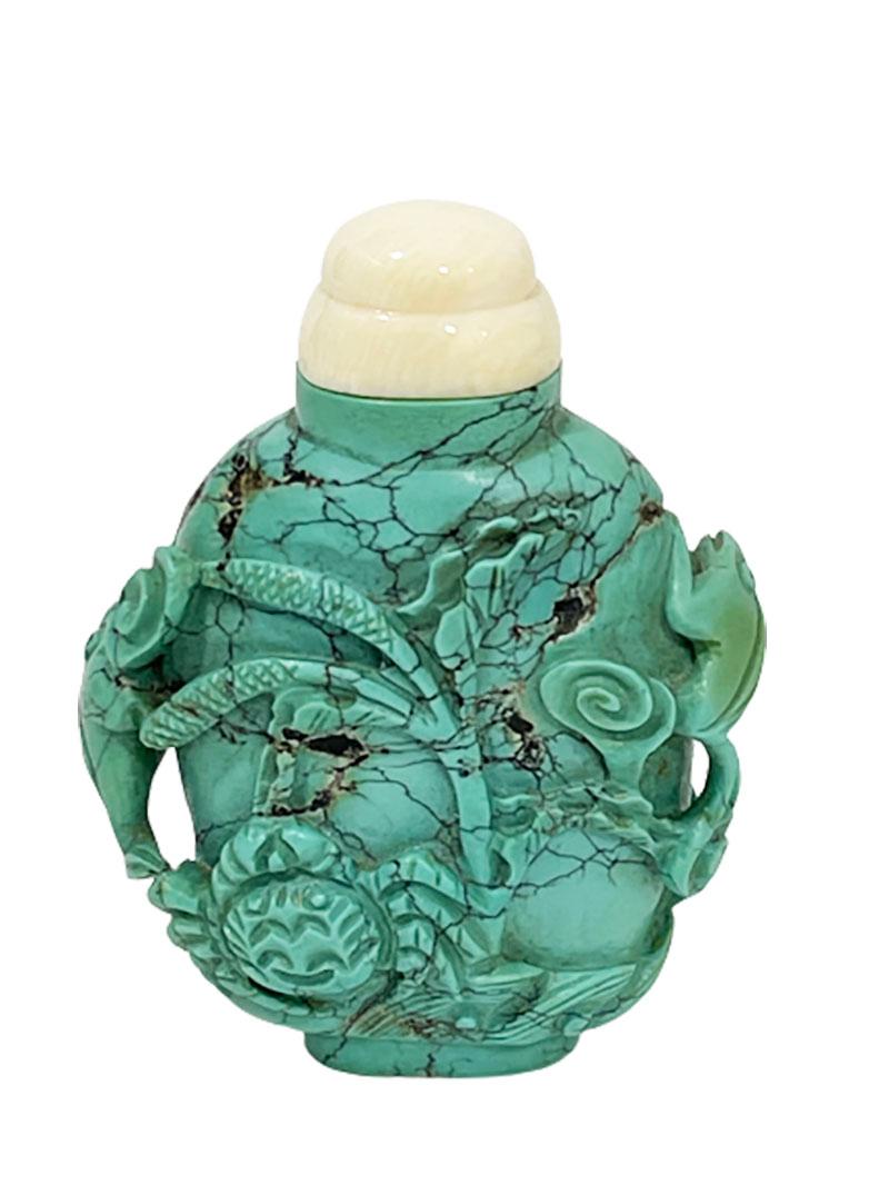 19th century Chinese turquoise snuff bottle

A snuff bottle cut out by hand in turquoise. The scene is a Chinese figure with very long braids standing on a lotus leaf
On the side left and right a frog. At the back, the sea waves with a crab and a