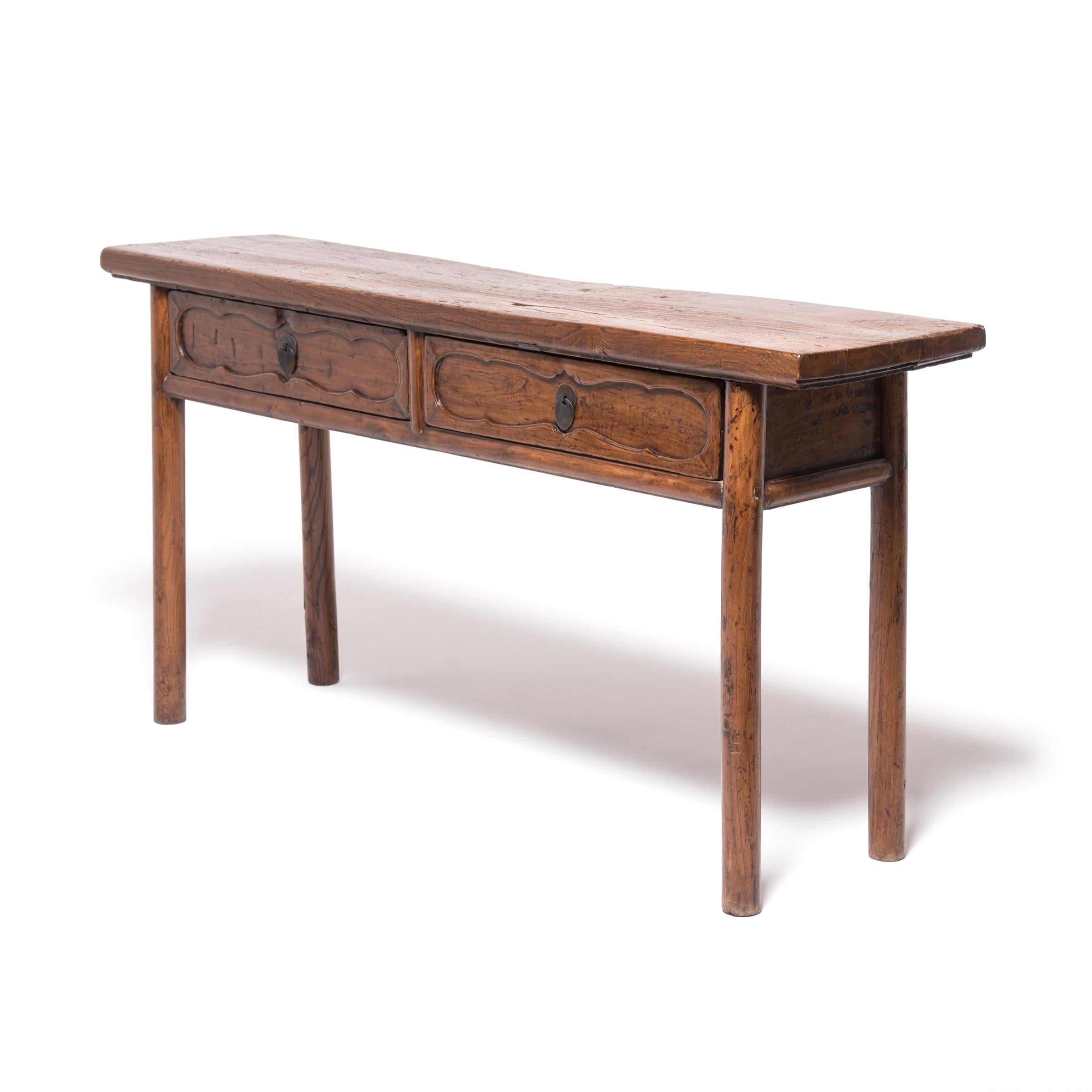 The warm patina of timeworn wood and straightforward styling earn this altar table a place in any room. Made in Northern China in the mid-19th century, the table was once used to hold offerings as part of ancestor worship in the home. Showcasing the
