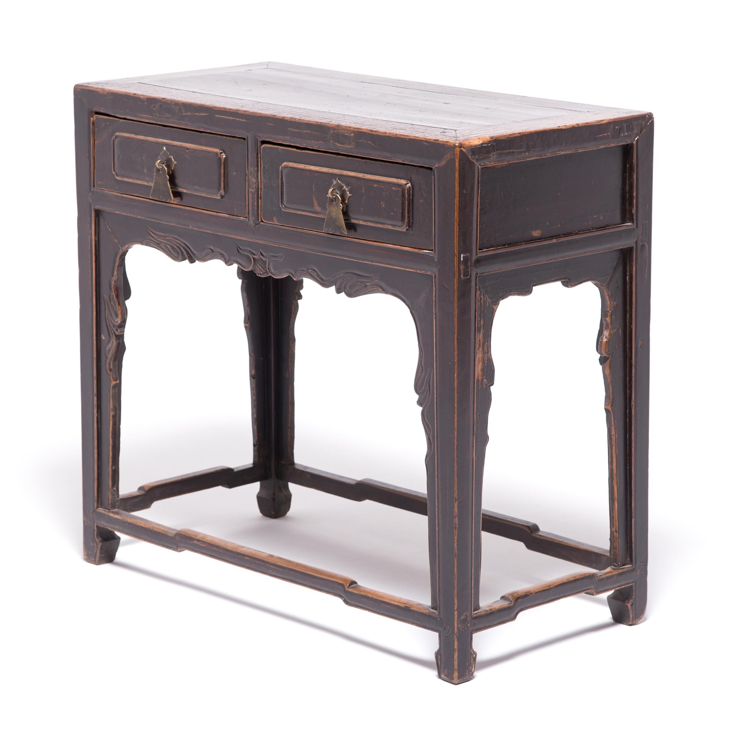 The worn edges and rich patina of this two-drawer table serve to outline this 19th century provincial table’s elegant lines. Made of northern Chinese elm (yumu) favored by woodworkers for its durability as well as beauty, the table has an elegantly