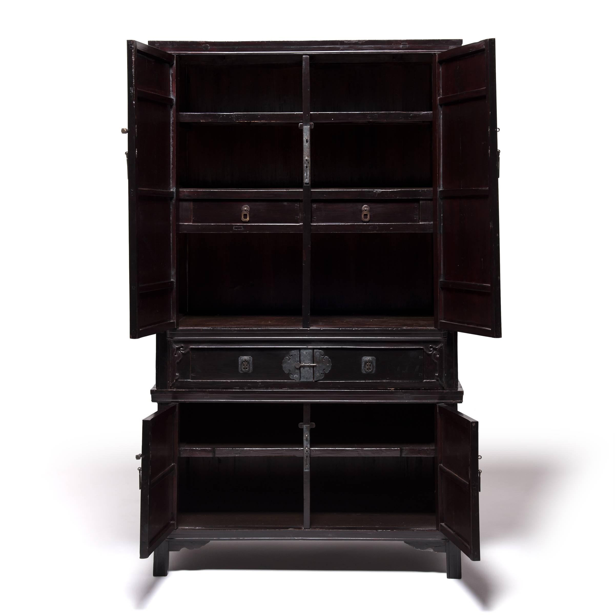 Classic Chinese furniture design is characterized by the flawless construction, purity of line, and dedication to detail you see here in this beautiful two-piece stacking cabinet. The Fujian artisan who carved this cabinet from cedar over 150 years