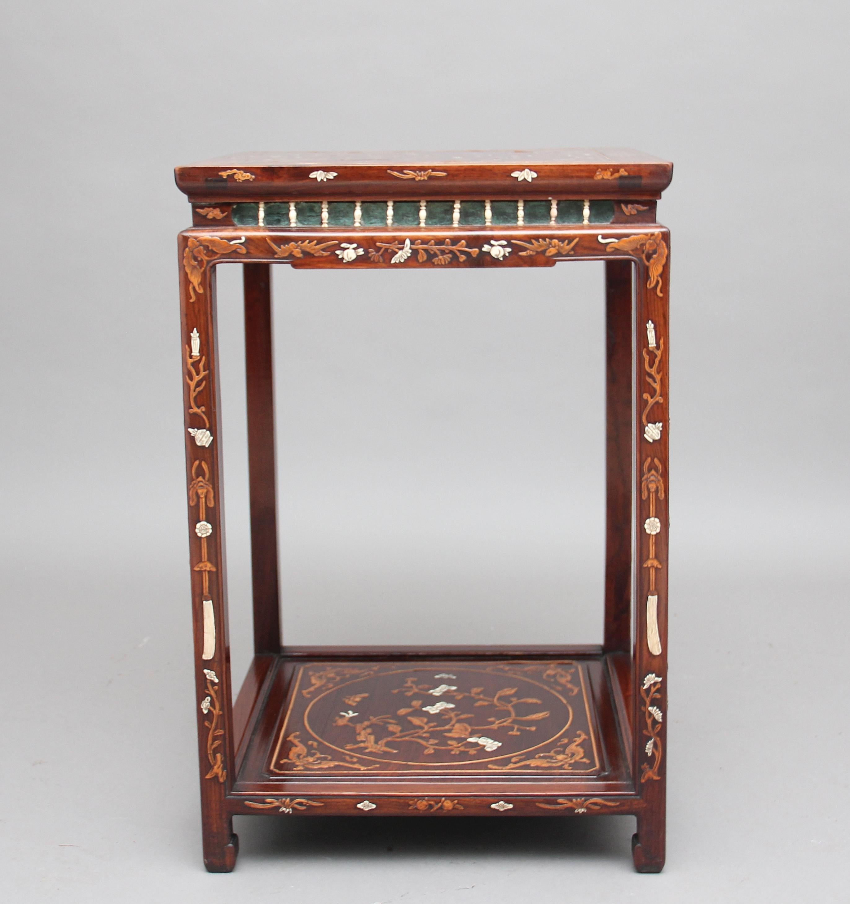 A decorative 19th century Chinese rosewood two-tier occasional table profusely inlaid all over with bone and wood inlay, the square top heavily inlaid with various floral decoration, symbols and creatures, the centre of the top depicting a Chinese