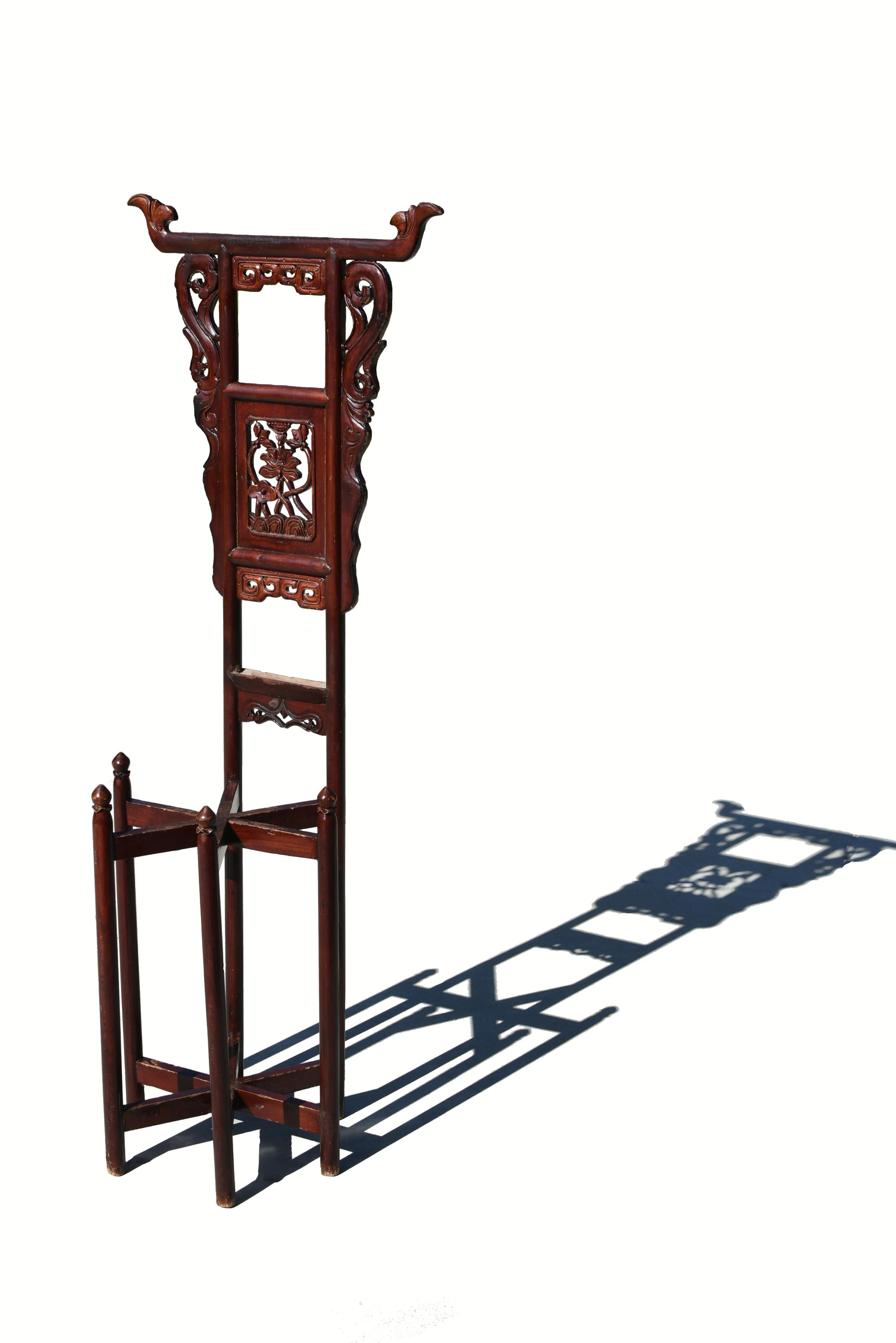 A beautiful 19th century Chinese wash stand of solid fir wood, hand carved with peonies in the center splat. Under the top rail which is decorated with carved flanges, a pair of carved dragon scrolls flank a horizontal double dragon scrolls, the