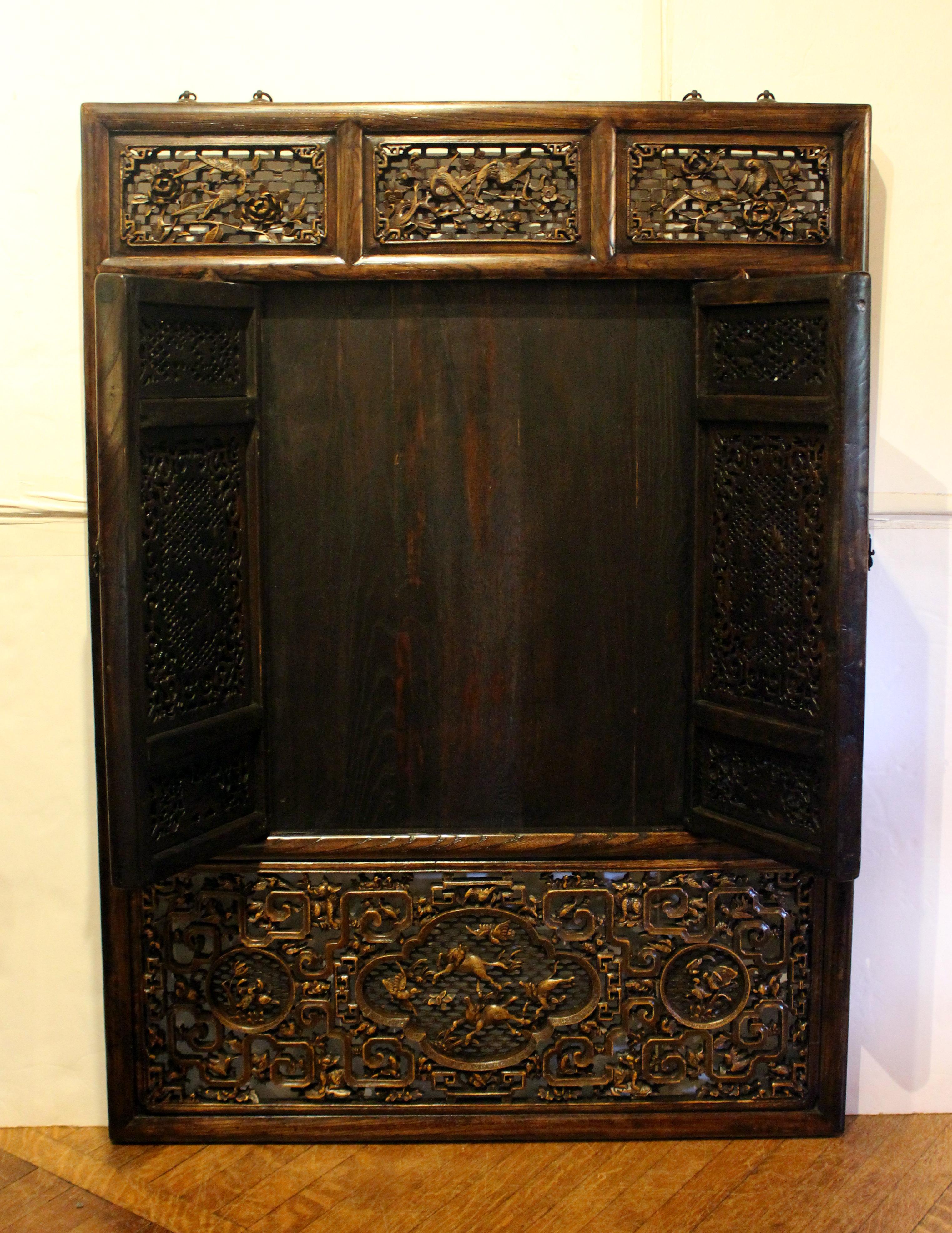 19th century Chinese window screen panel. Carved elm. Elaborately carved featuring panels of birds, mythical creatures & other animals. Makes a wonderful architectural wall hanging or could be incorporated into an architectural opening. 35 3/4