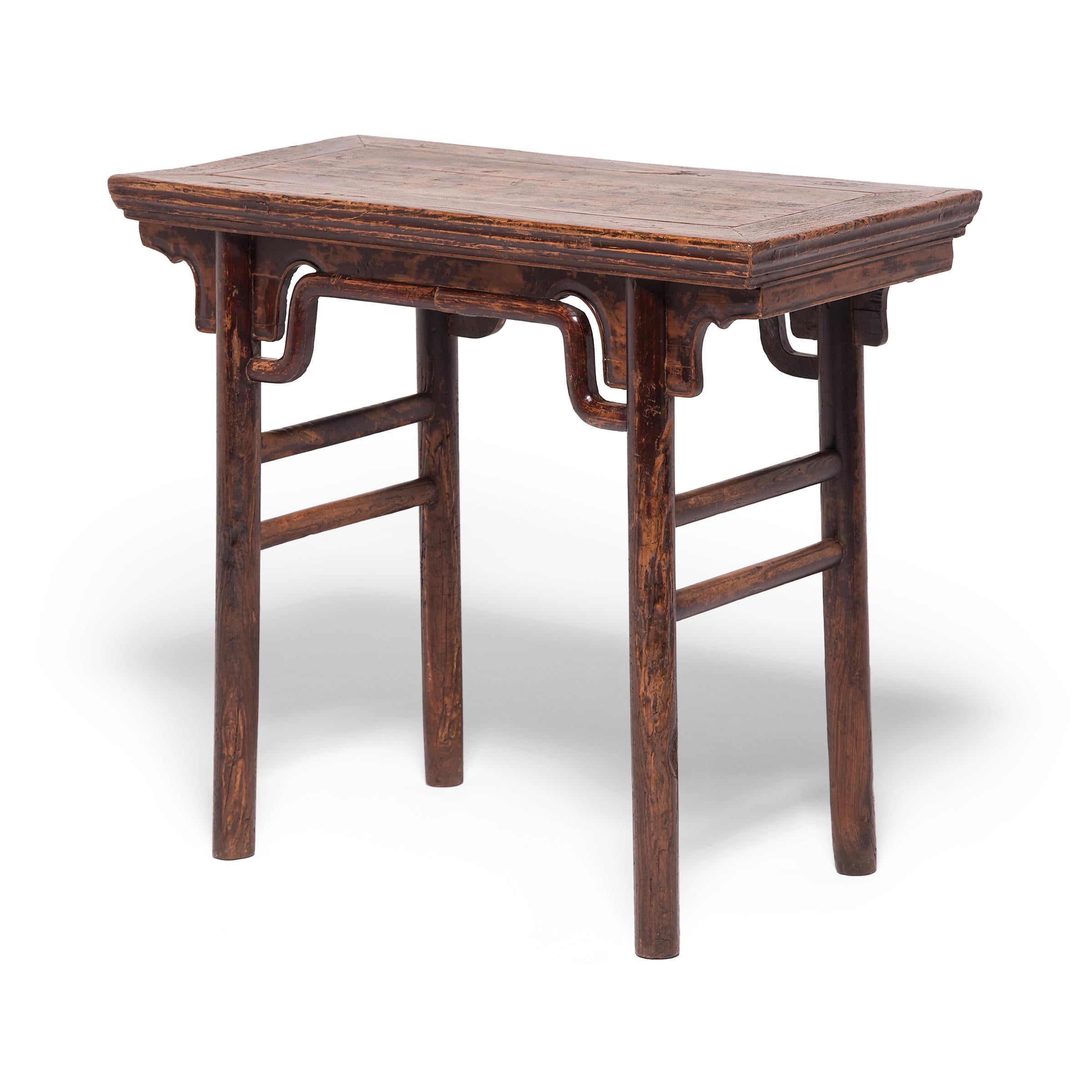 The elegant design of this 19th century table is inspired by earlier Ming dynasty furniture designs highly prized by collectors. Clean lines, simple humpback stretchers, and a beautifully worn patina only add to the console table's value. The