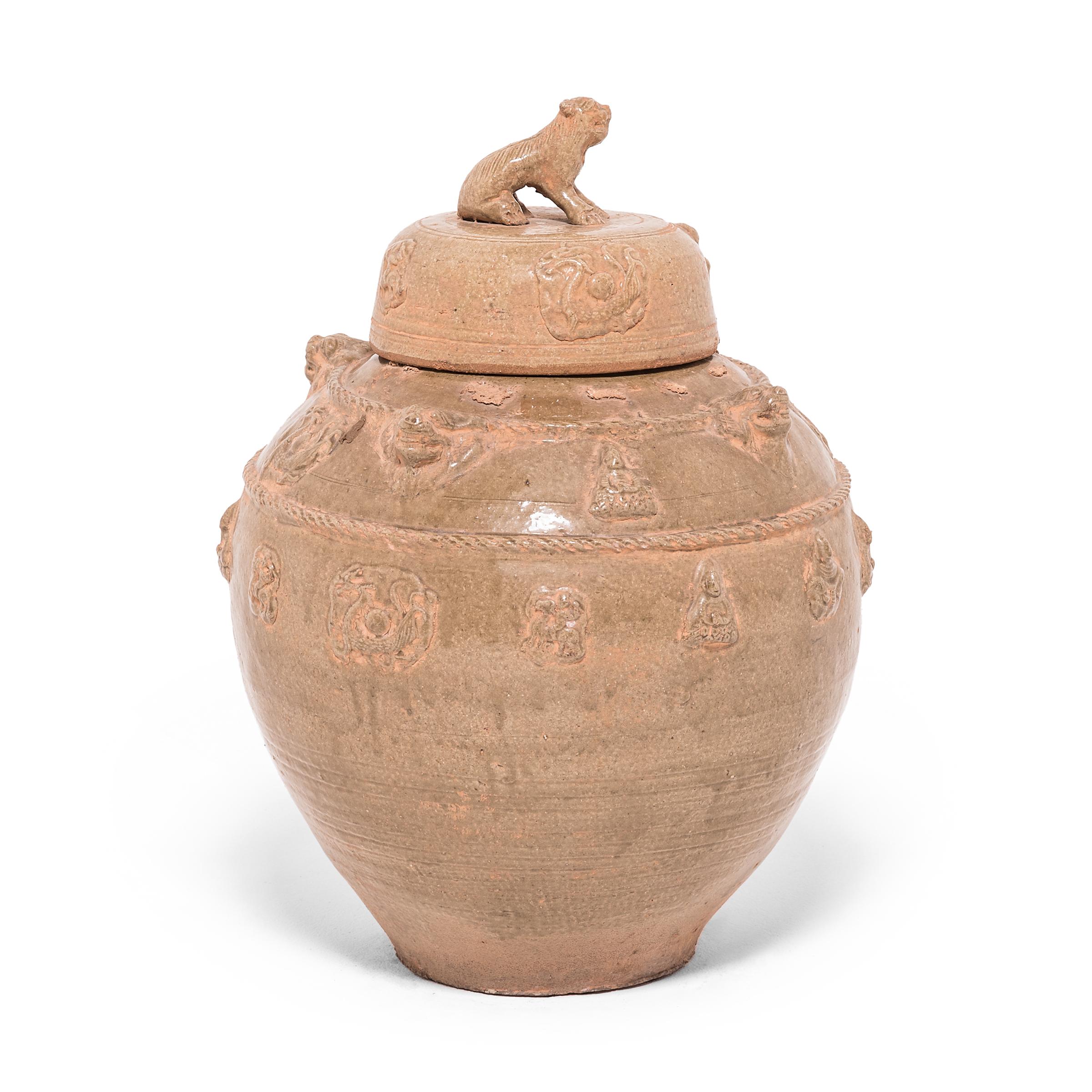 This ceramic vessel was handcrafted in the Jiangxi region of China in the spirit of ancient temple jars. The style and glaze is reminiscent of Han dynasty burial vessels designed to store wine for passage to the afterlife. The jar is decorated in