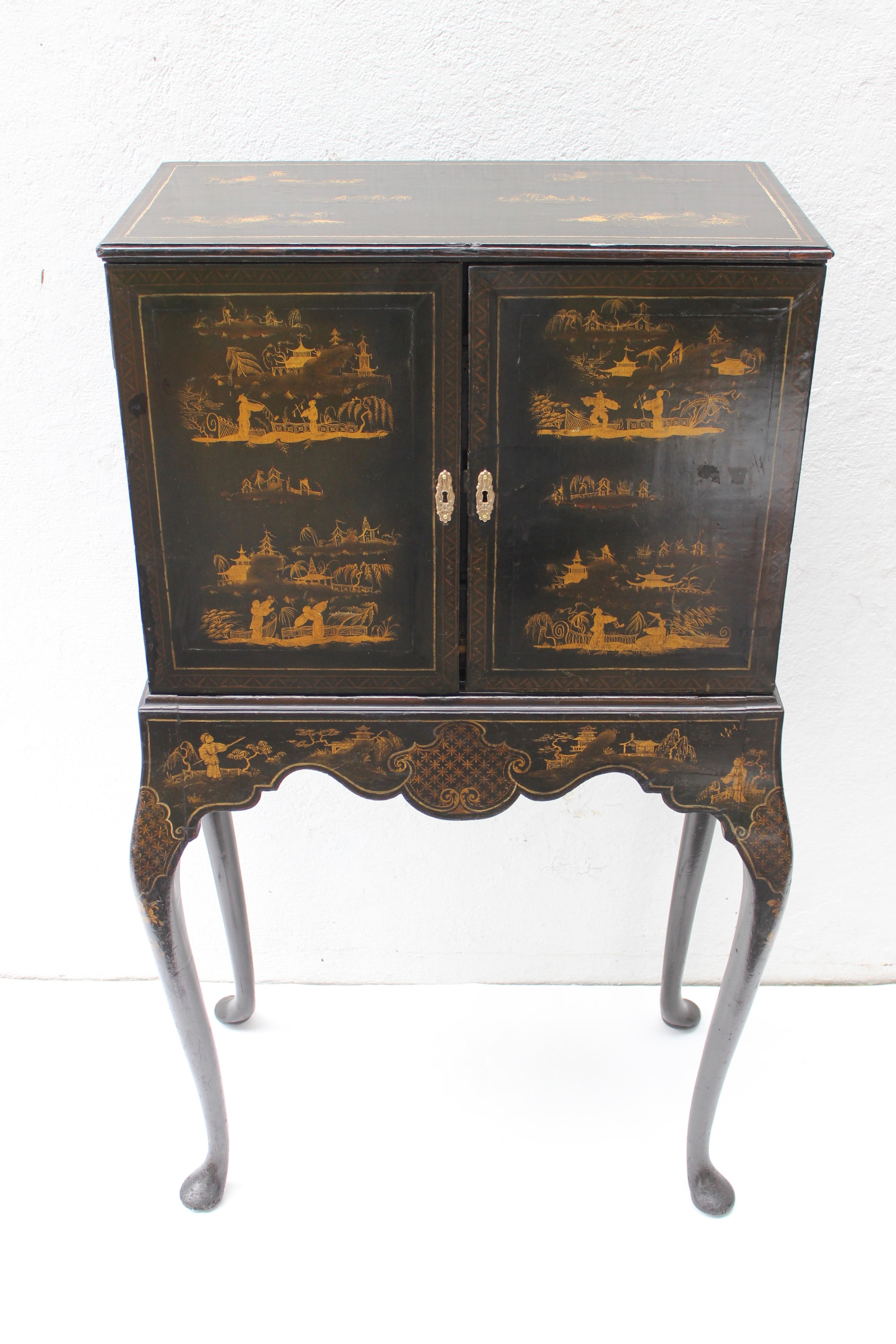 19th century chinoiserie collector's cabinet on gilt and ebonized decorated apron over Queen Anne's style cabriole legs.