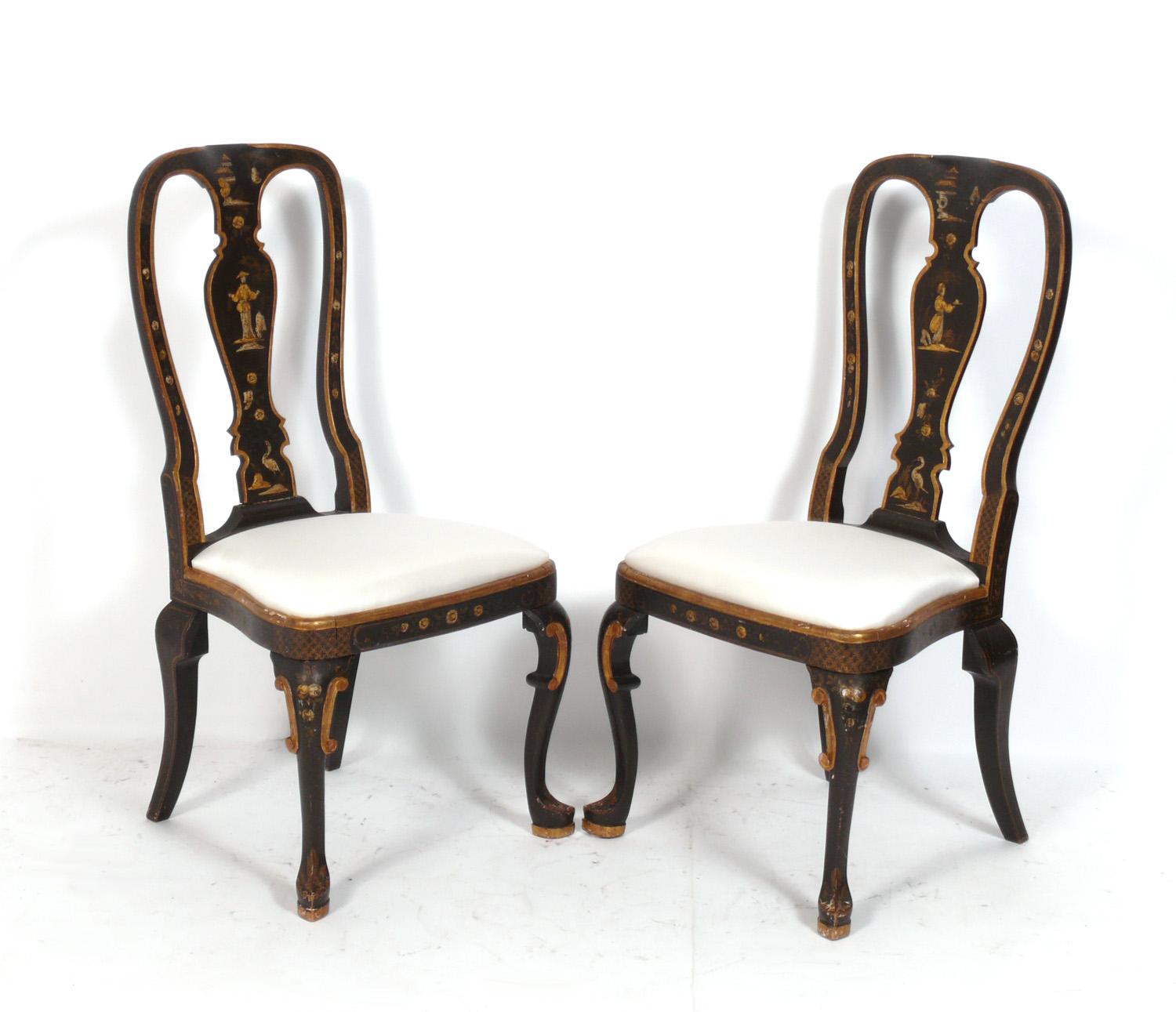 Pair of 19th century chinoiserie chairs, probably made for the Chinese Export market to England, circa 19th Century. They feature hand carved gilt designs over a deep brown lacquer. They have recently been reupholstered in an ivory color silk.